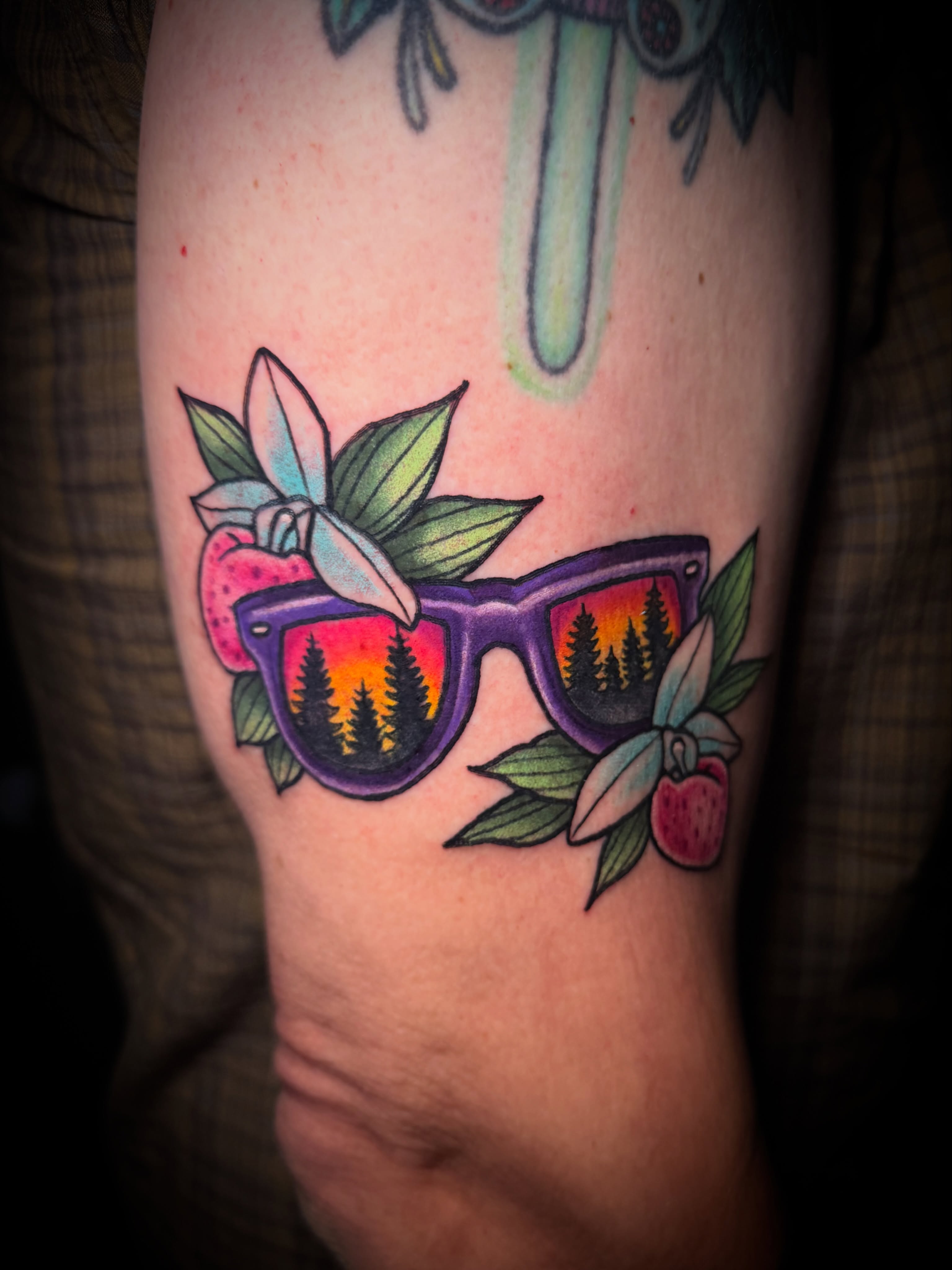 Sunglasses with forest reflection American traditional tattoo on the forearm by Tyler Jewett