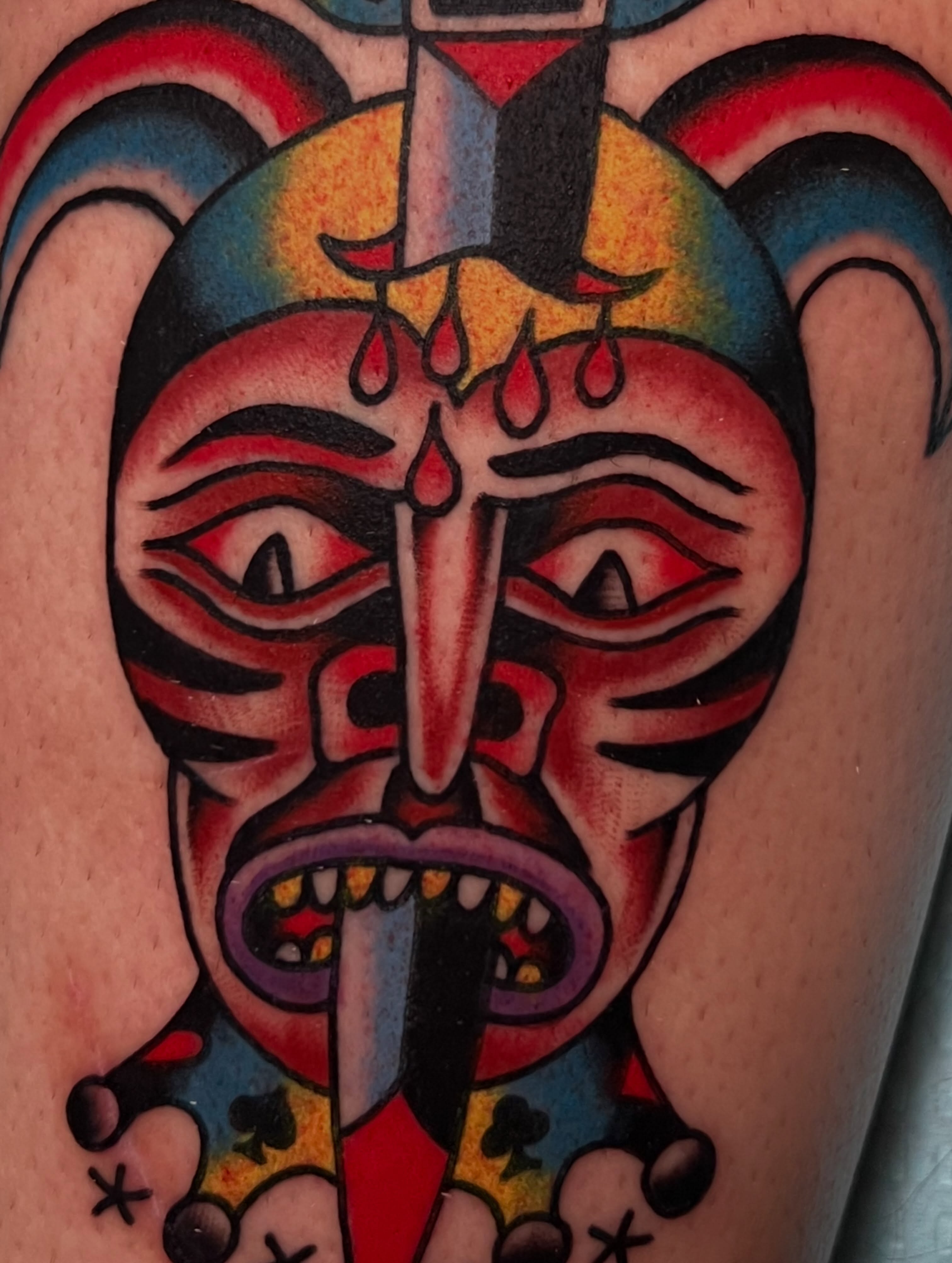Mask with knife American traditional tattoo on the forearm by Charlie Campanella