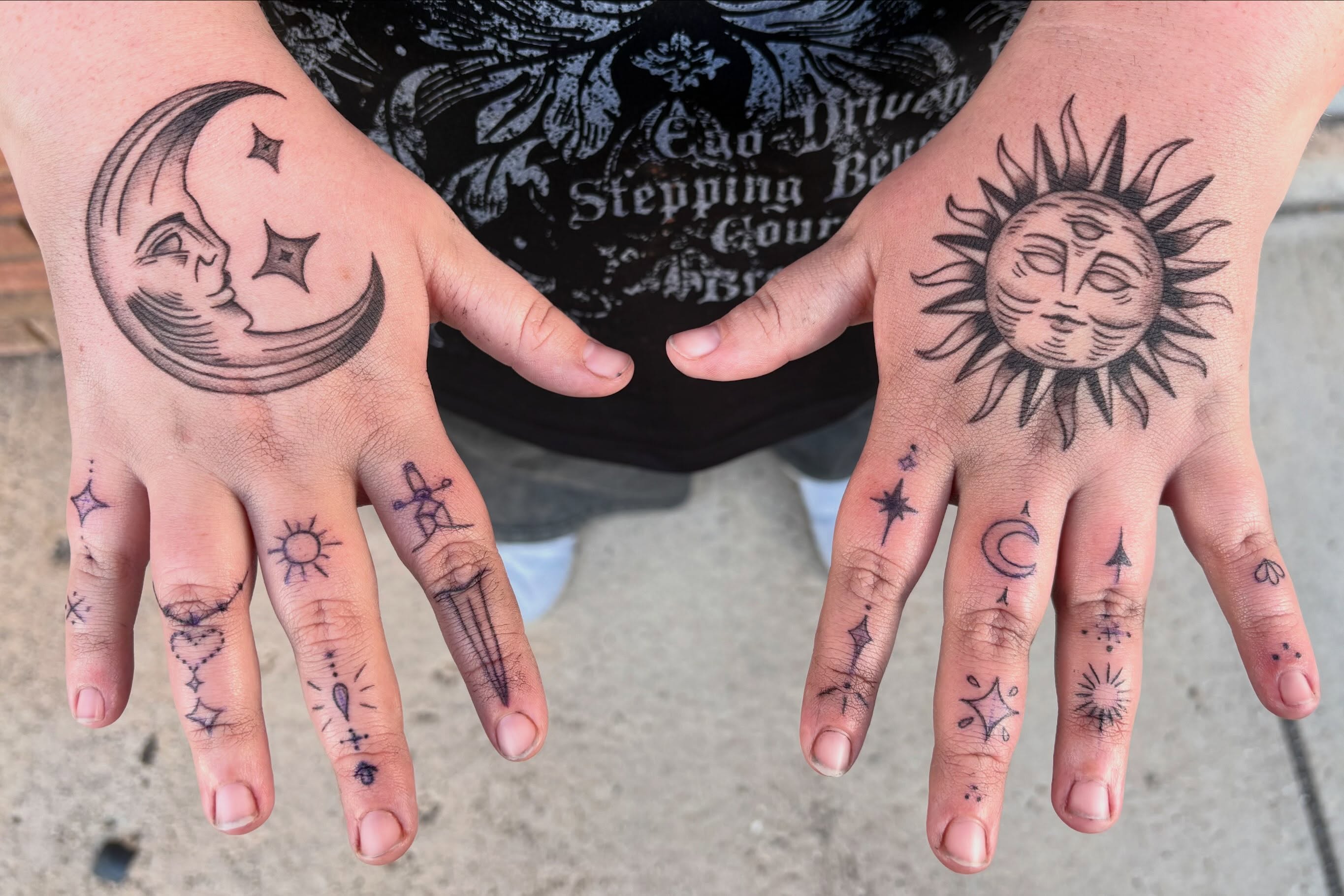 Sun and moon black and grey tattoo on the hand by Sierra Maynard