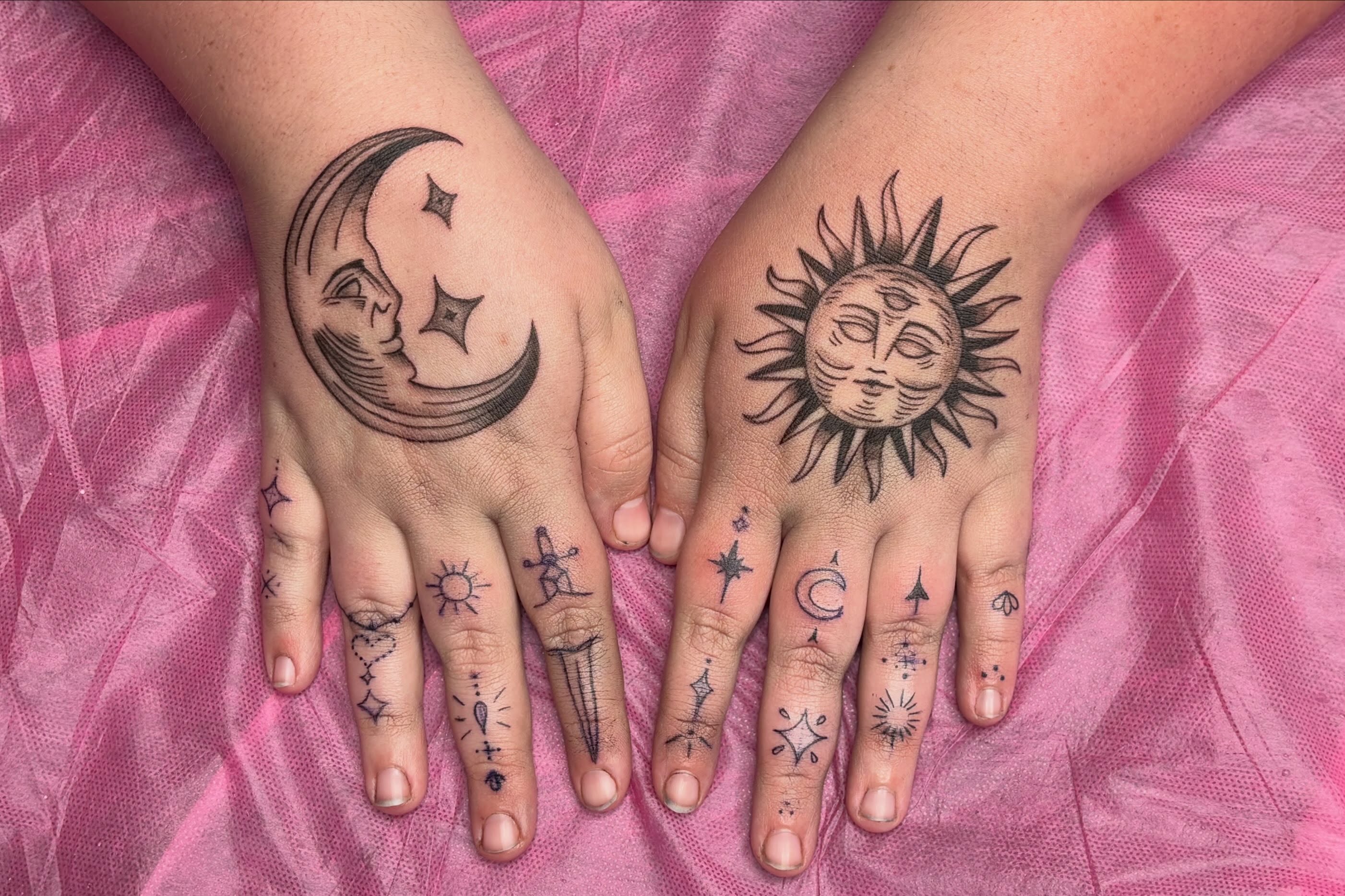 Sun and moon black and grey tattoo on the hand by Sierra Maynard