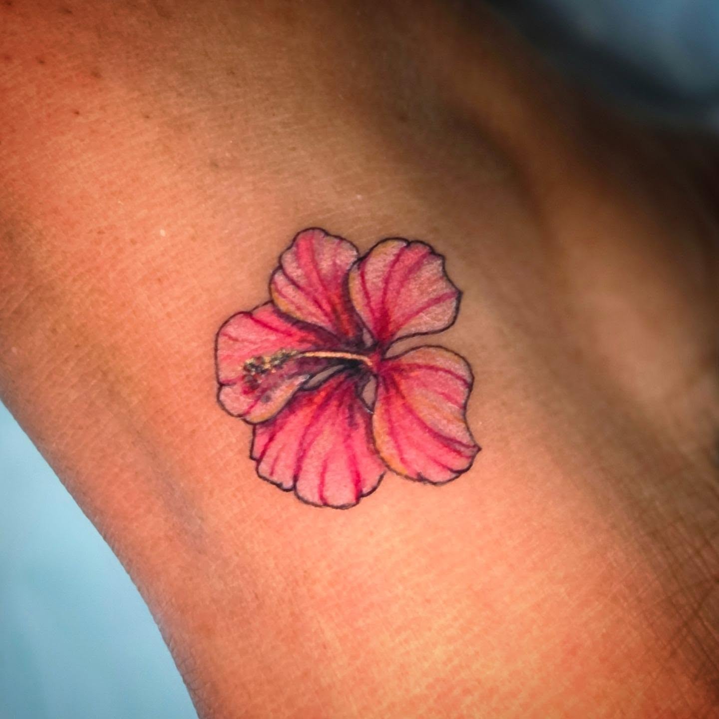 Hibiscus flower realism tattoo on the forearm by Kassy Fiori