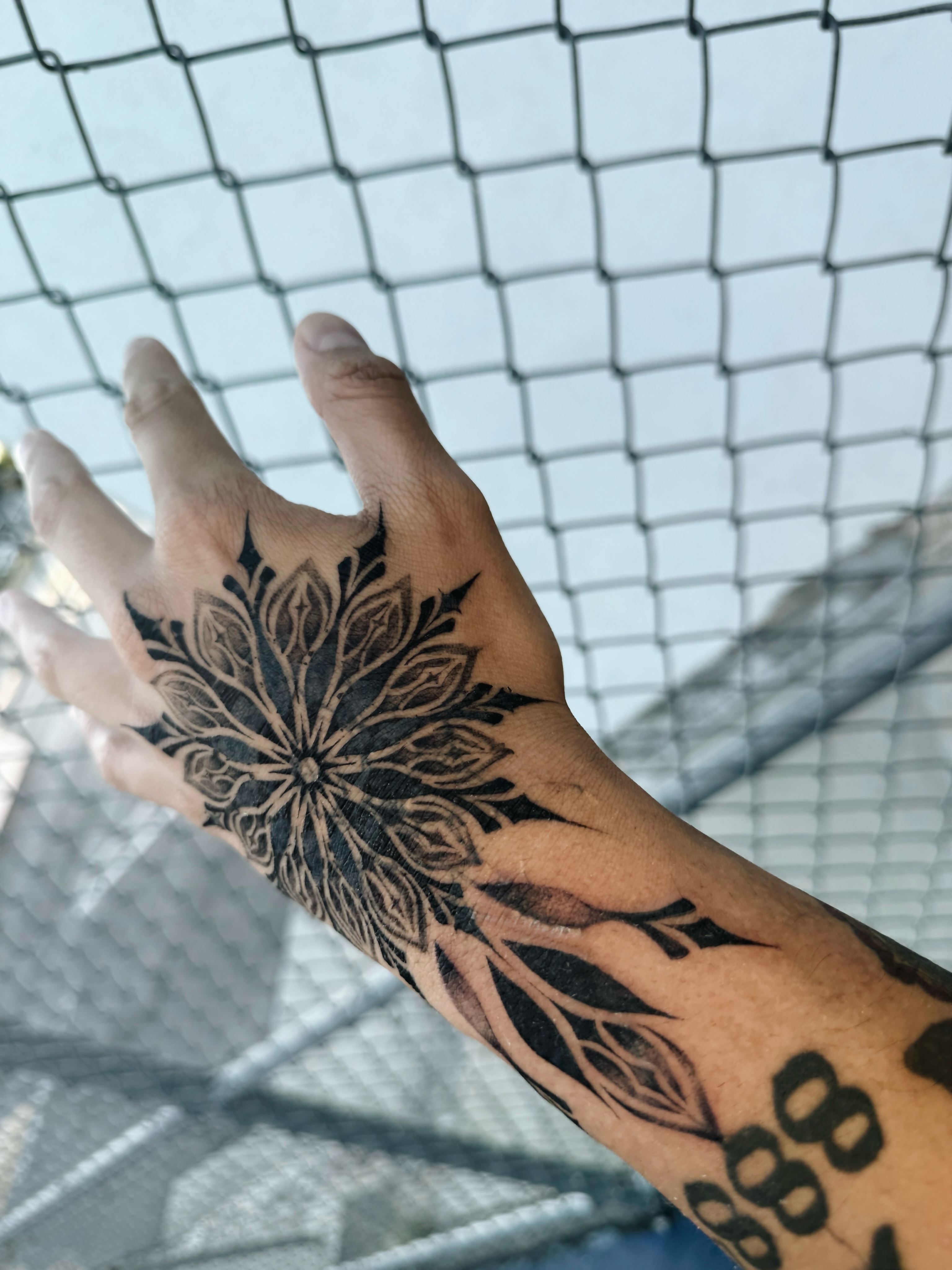 Floral mandala black and grey tattoo on the hand by viktoria raquel
