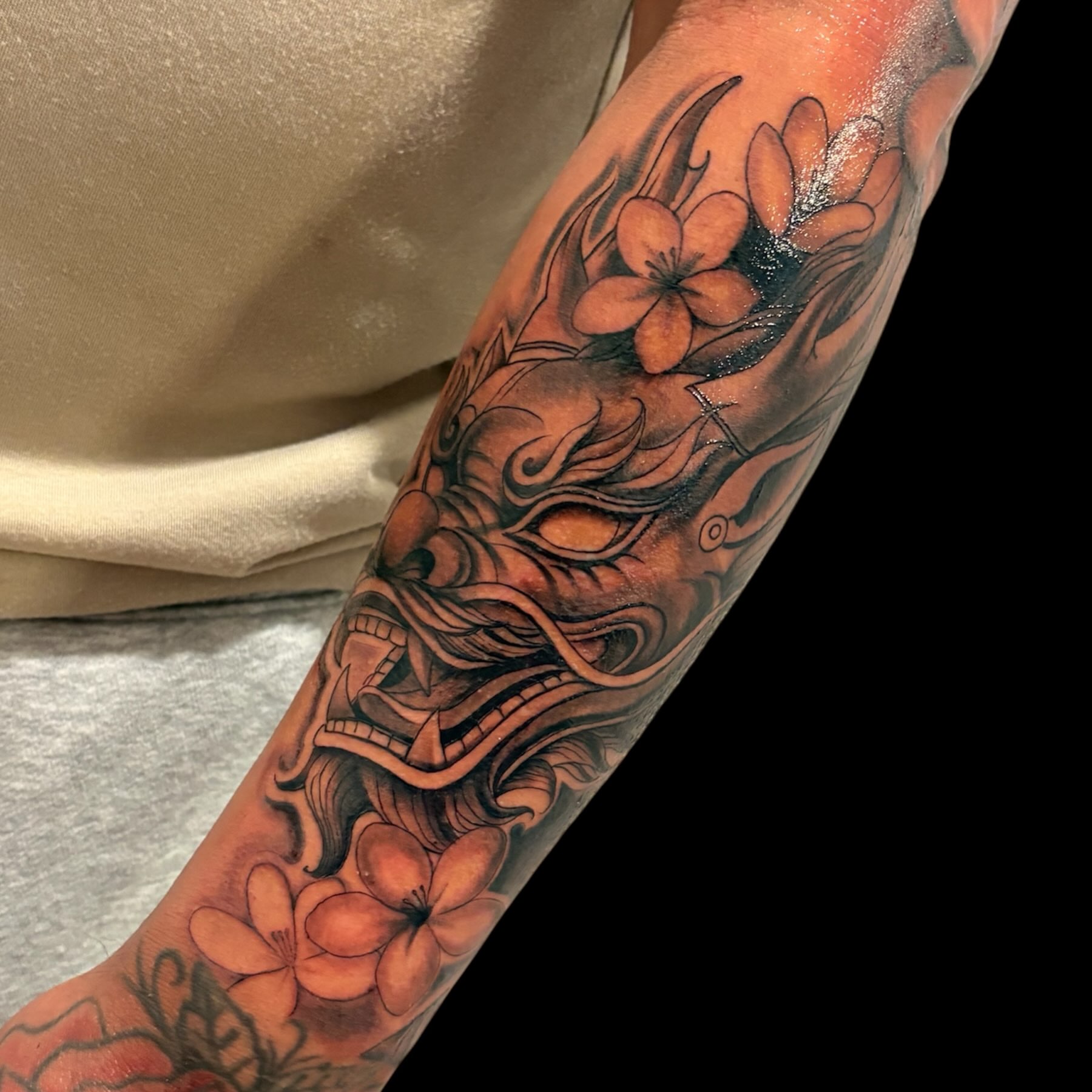 Mask with flowers japanese irezumi tattoo on the forearm by Tattoomobile