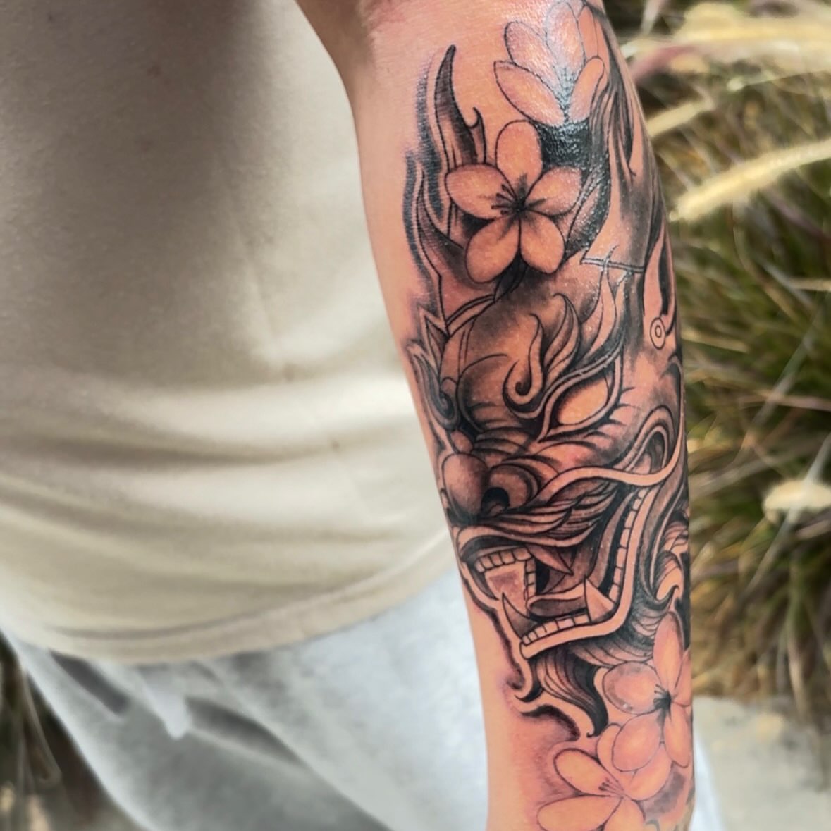 Dragon and flowers japanese irezumi tattoo on the forearm by Tattoomobile