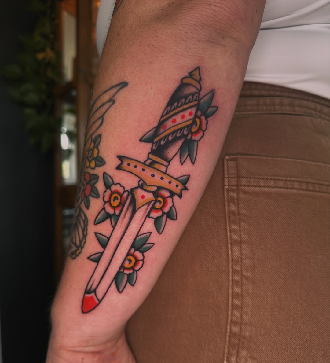 Rocket and flowers American traditional tattoo on the forearm by Max Peterson