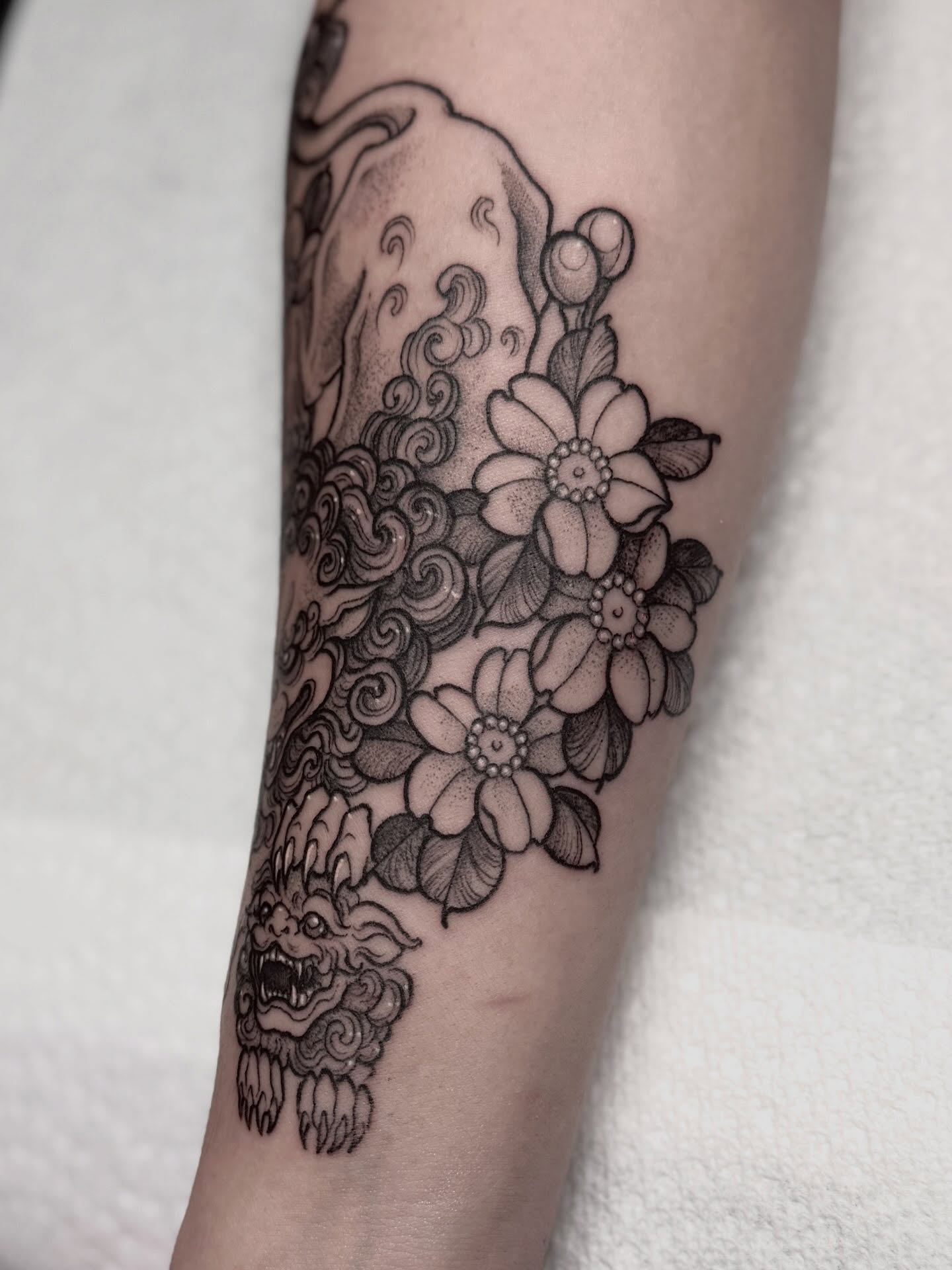 Cherry blossoms and dragon japanese irezumi tattoo on the forearm by Cincinnati