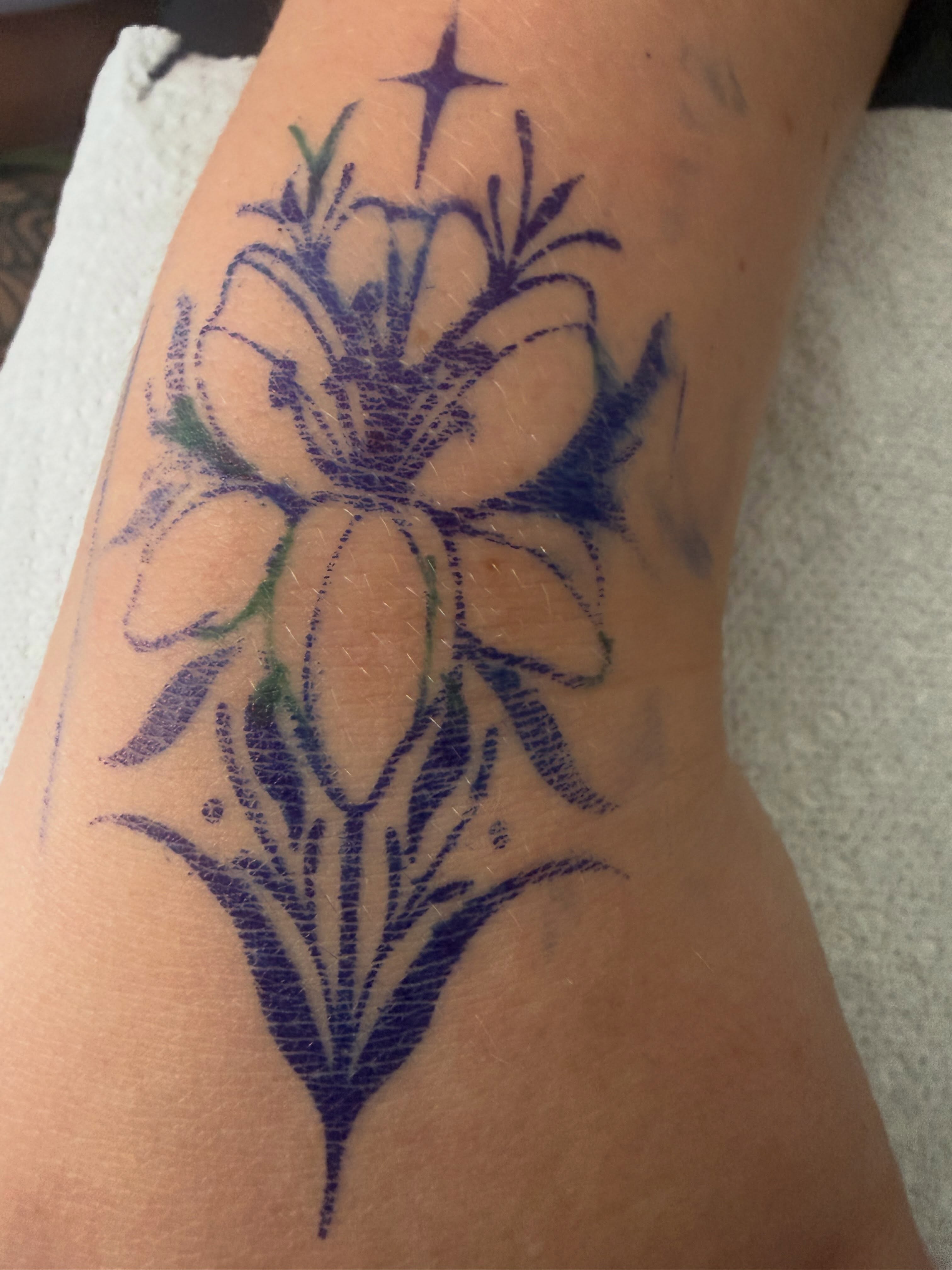 Lily black and grey tattoo on the forearm by Tatz By Benji