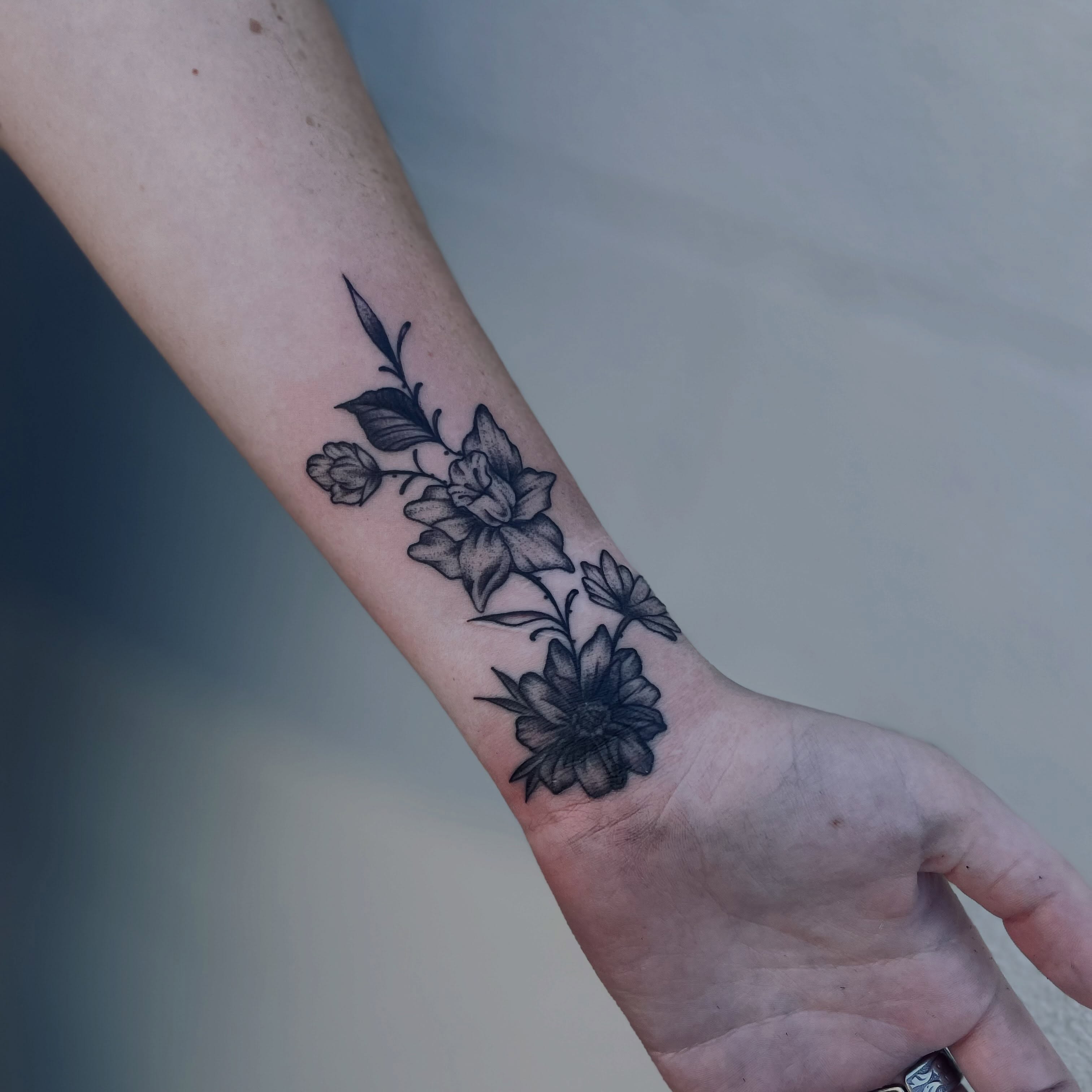 Flowers black and grey tattoo on the forearm by Christien Xavier Alba, Salt Lake City, Utah