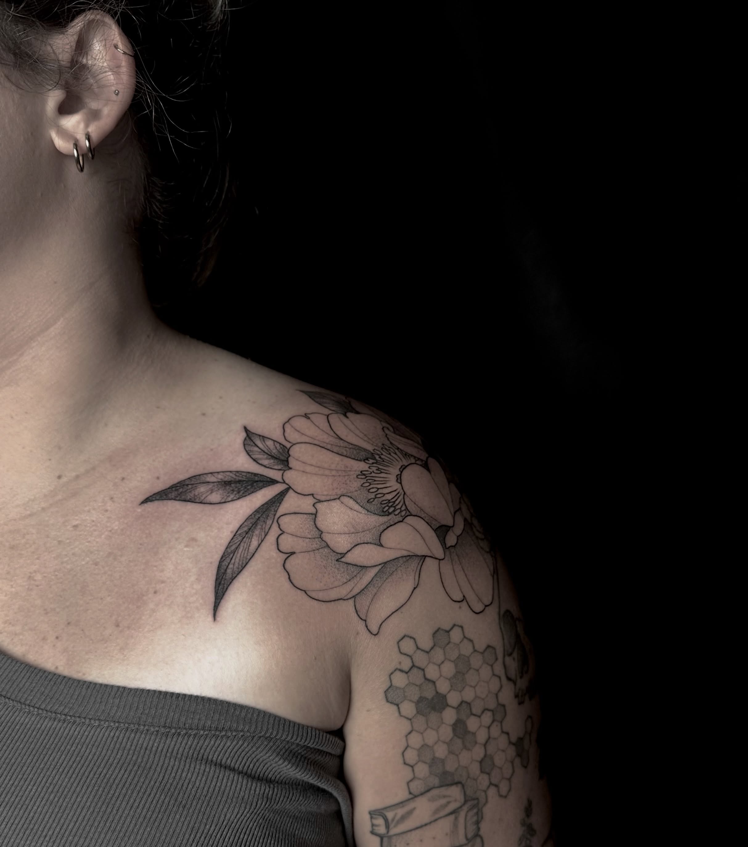 Flower black and grey tattoo on the shoulder by Zoe Arrigo