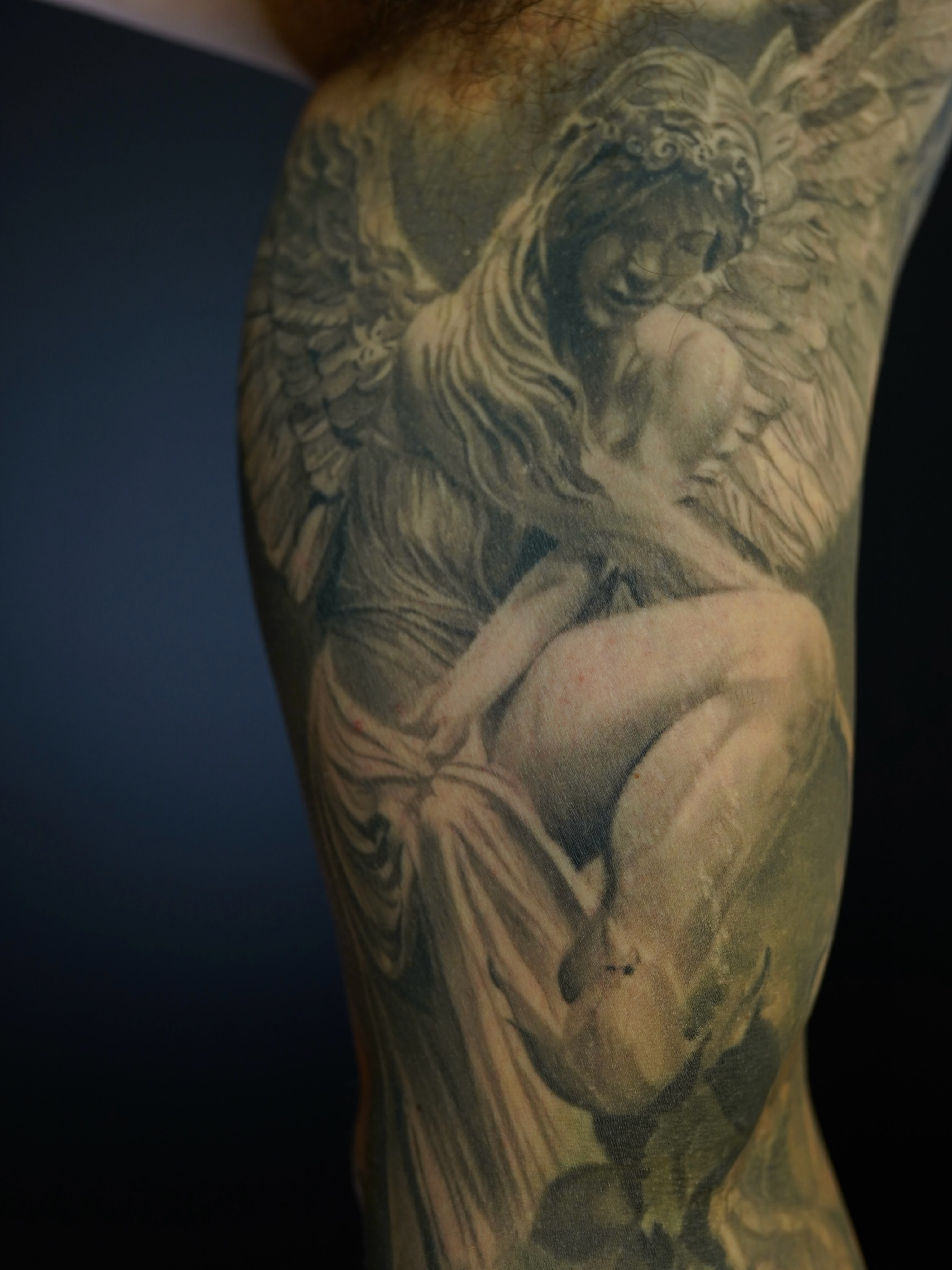 Angel and cherub realism tattoo on the forearm by Eric RudeInk