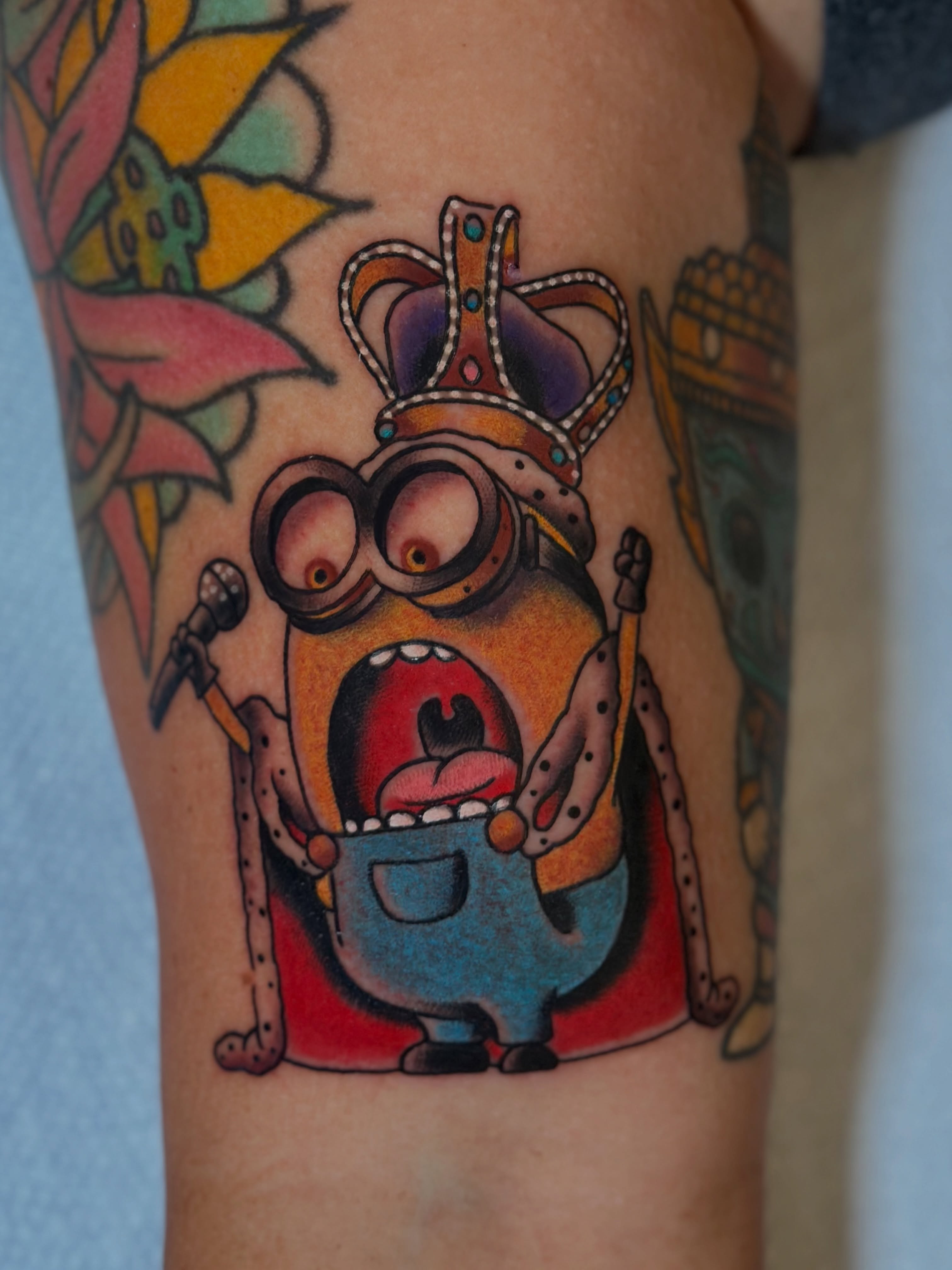 Minion with crown American traditional tattoo on the forearm by Michael Williams