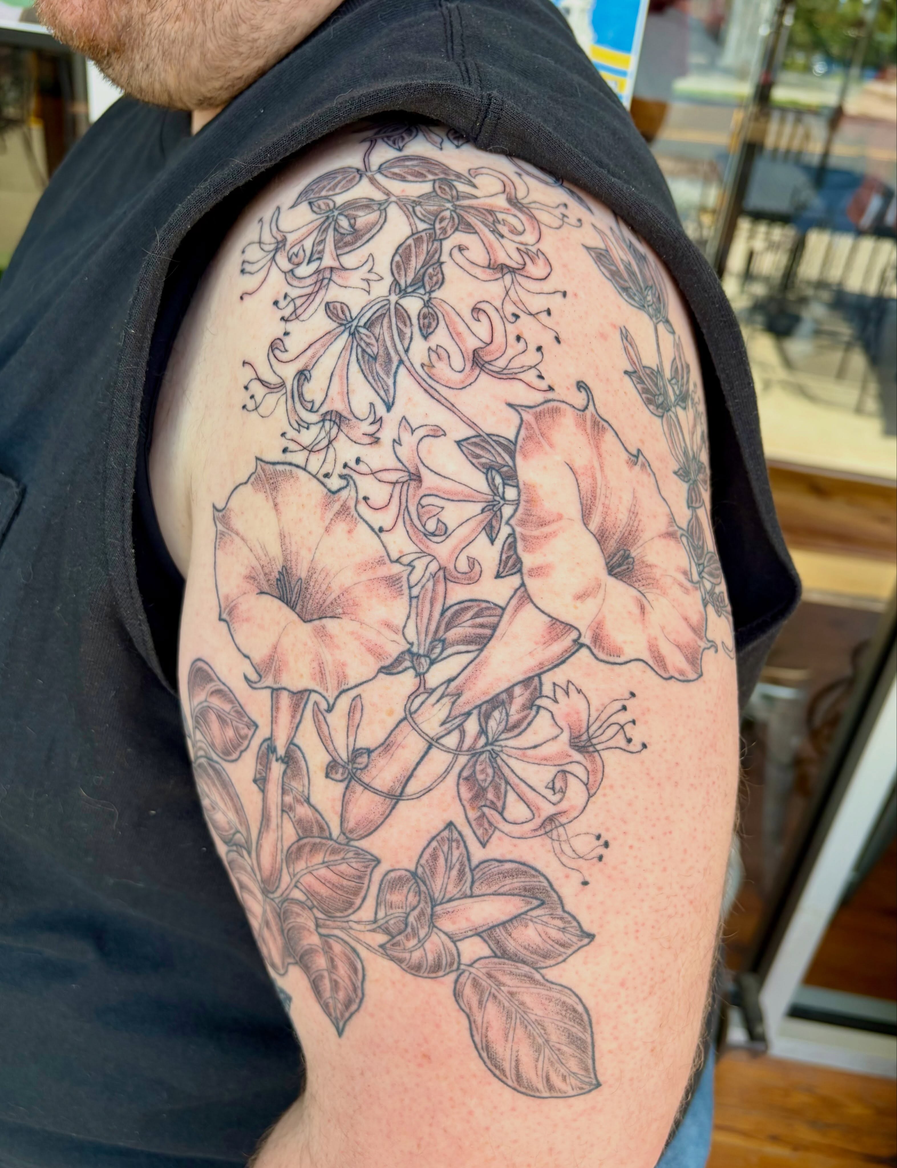 Morning glory flowers realism tattoo on the shoulder by Sarah Roach