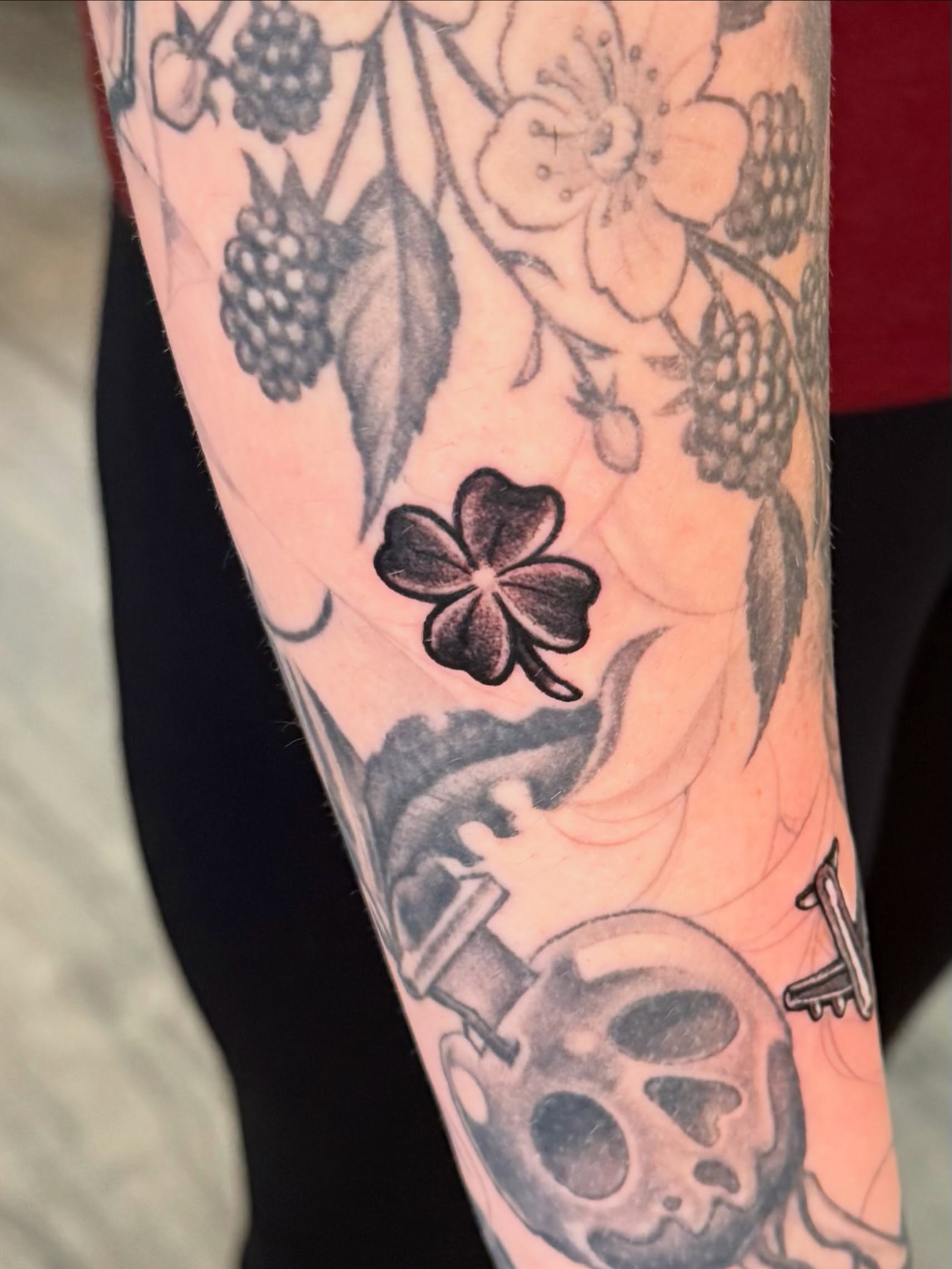 Clover black and grey tattoo on the forearm by Damon Moore