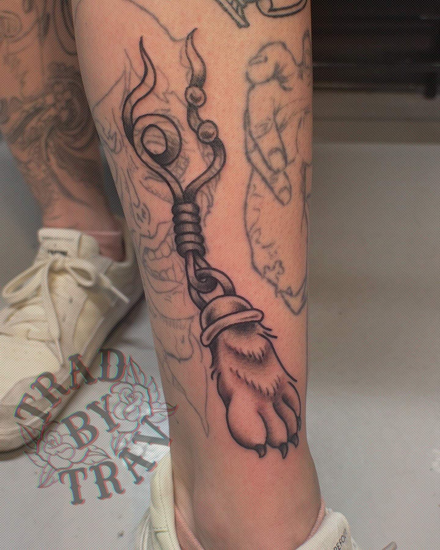 Bear paw with bell American traditional tattoo on the forearm by Travis B