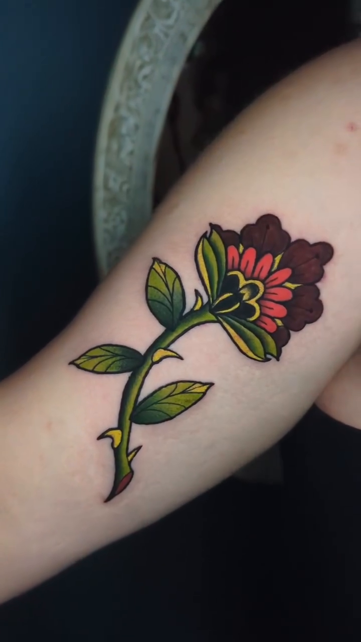 Rose tattoo neo-traditional tattoo on the forearm by Narnia Gallagher
