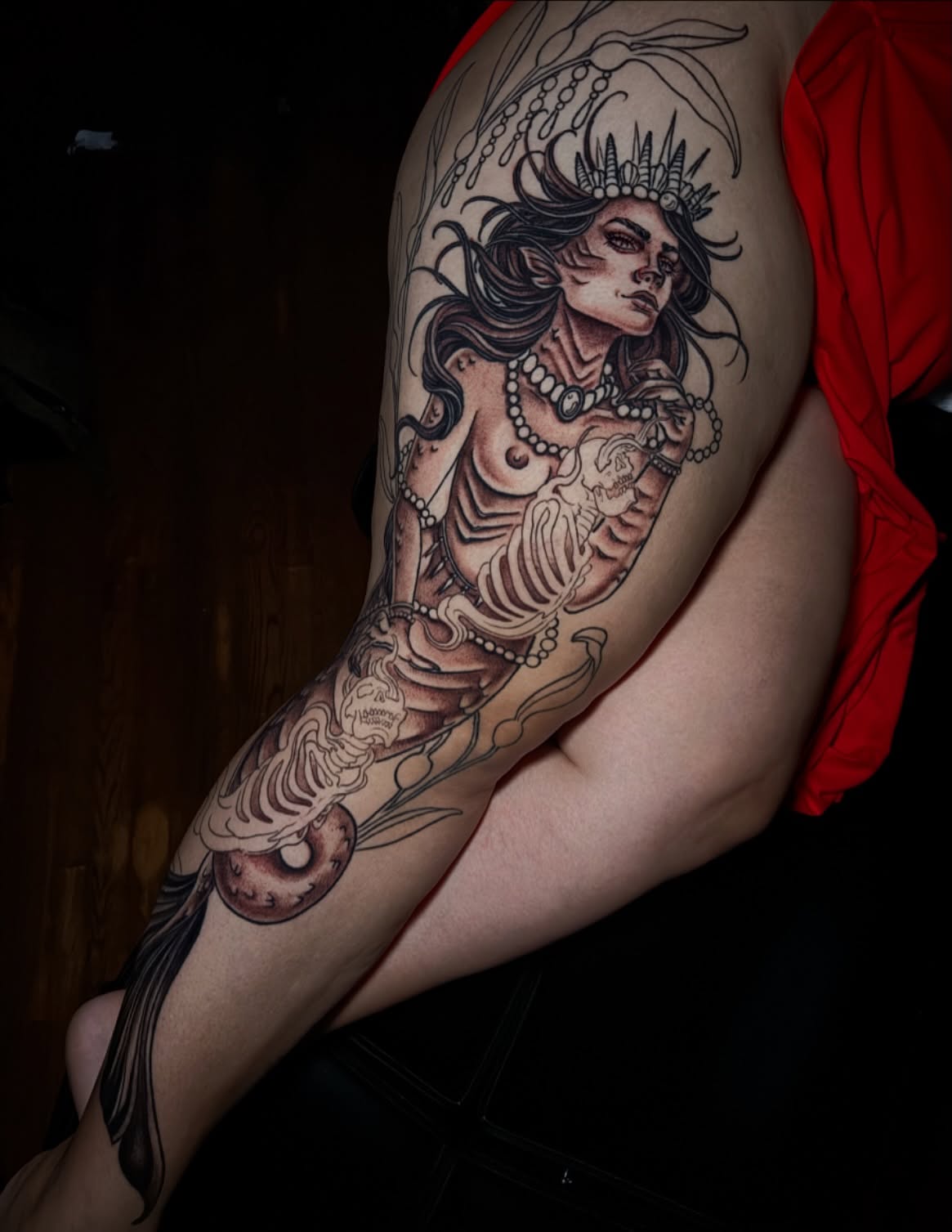 Woman with crown realism tattoo on the upper arm by Dee Florian