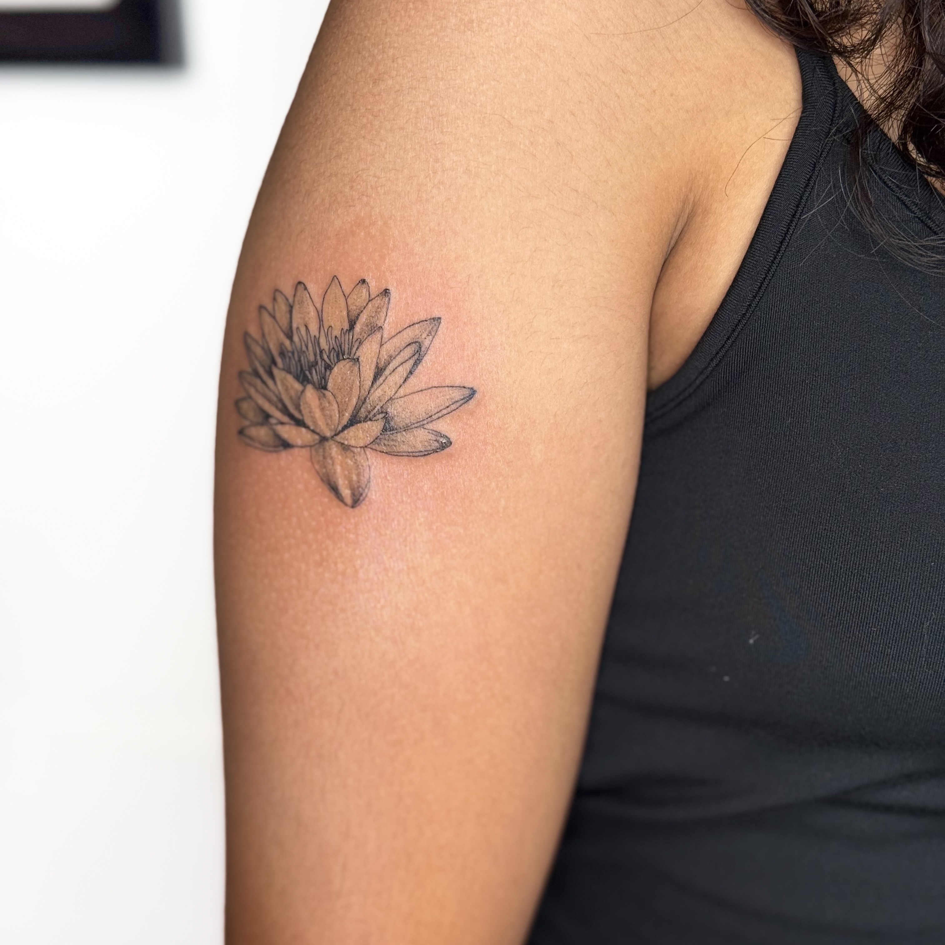 Lotus flower black and grey tattoo on the upper arm by ❁ Marlo Marquise Tattoo Artist ❁