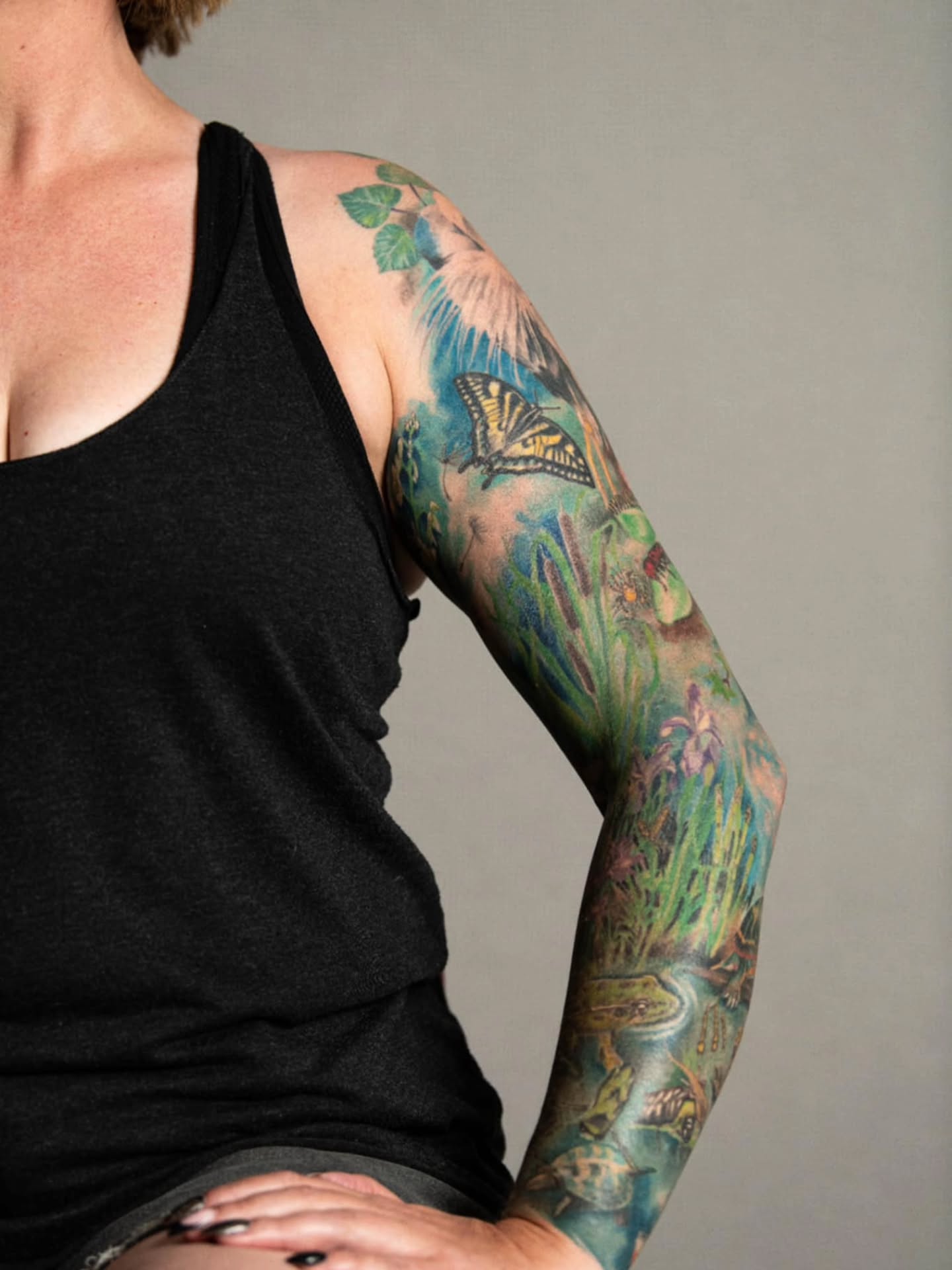 Butterfly and frog realism tattoo on the upper arm by Heather