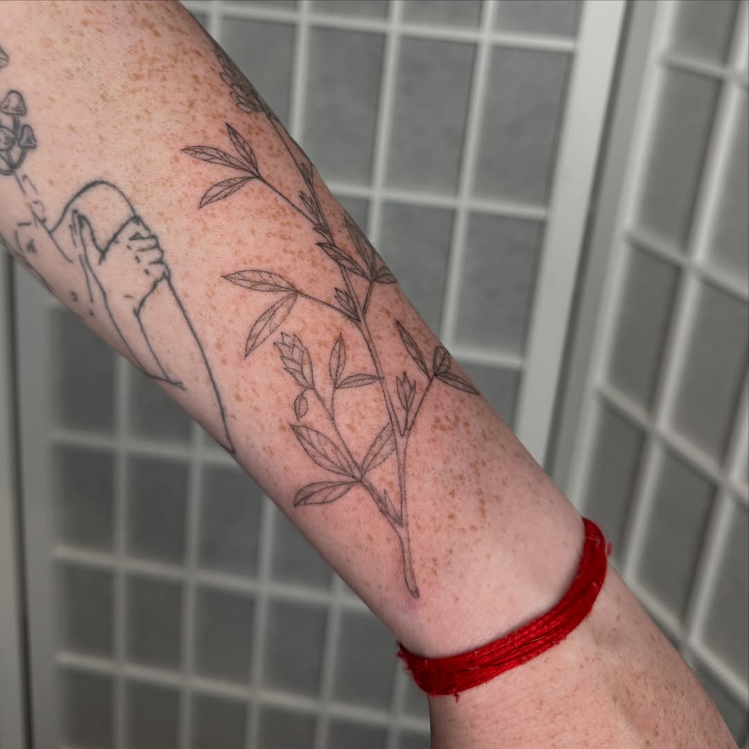 Botanical branch black and grey tattoo on the forearm by Dama