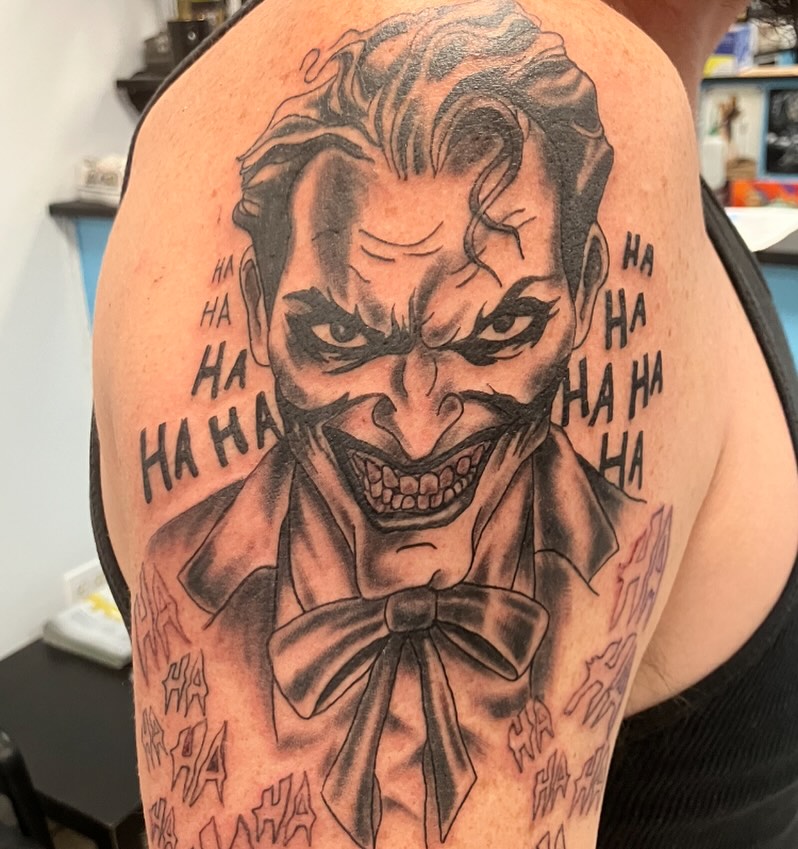 Joker black and grey tattoo on the shoulder by Bryant Johnson