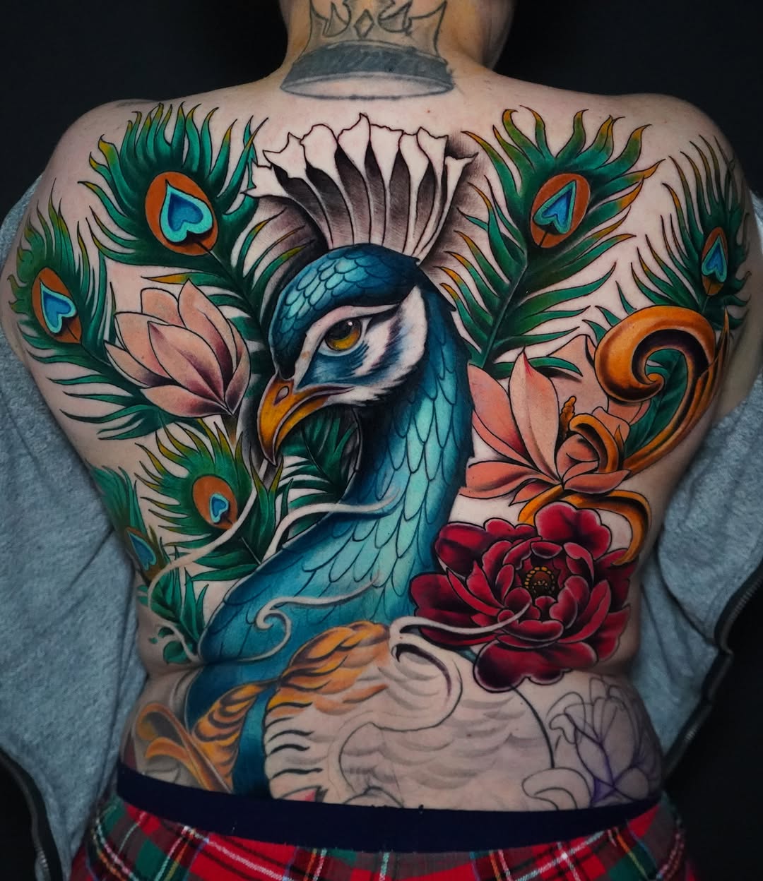 Peacock and floral new school tattoo on the back by Eric Zuluaga
