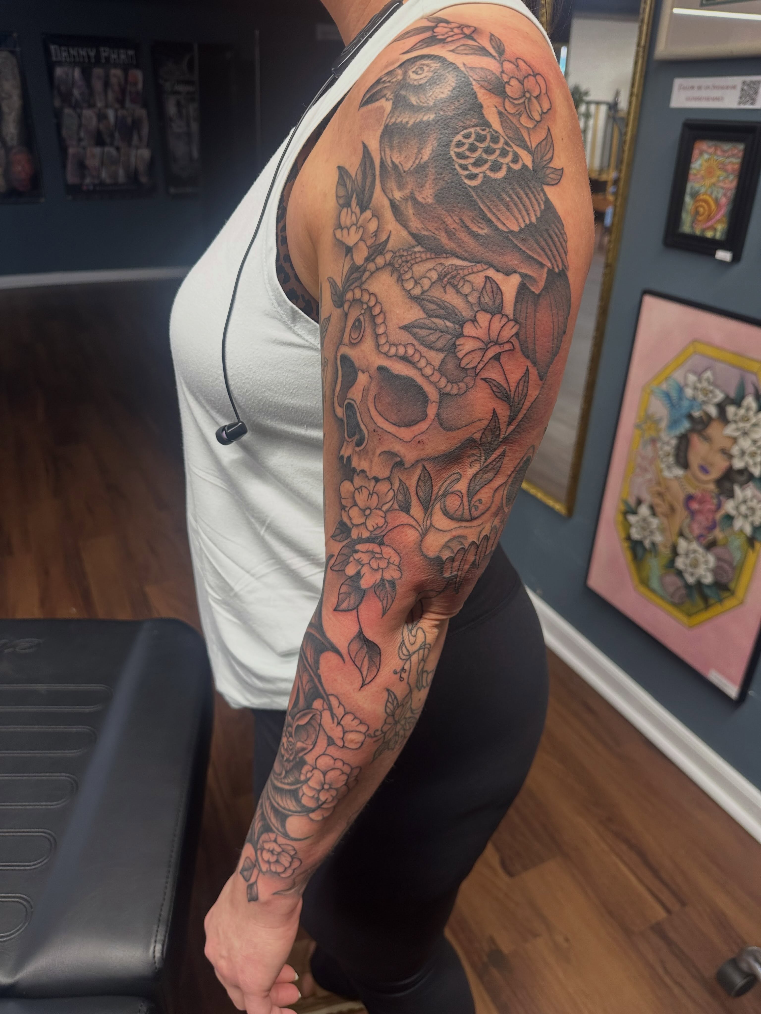 Bird and skull American traditional tattoo on the upper arm by Lindsey Bendsey
