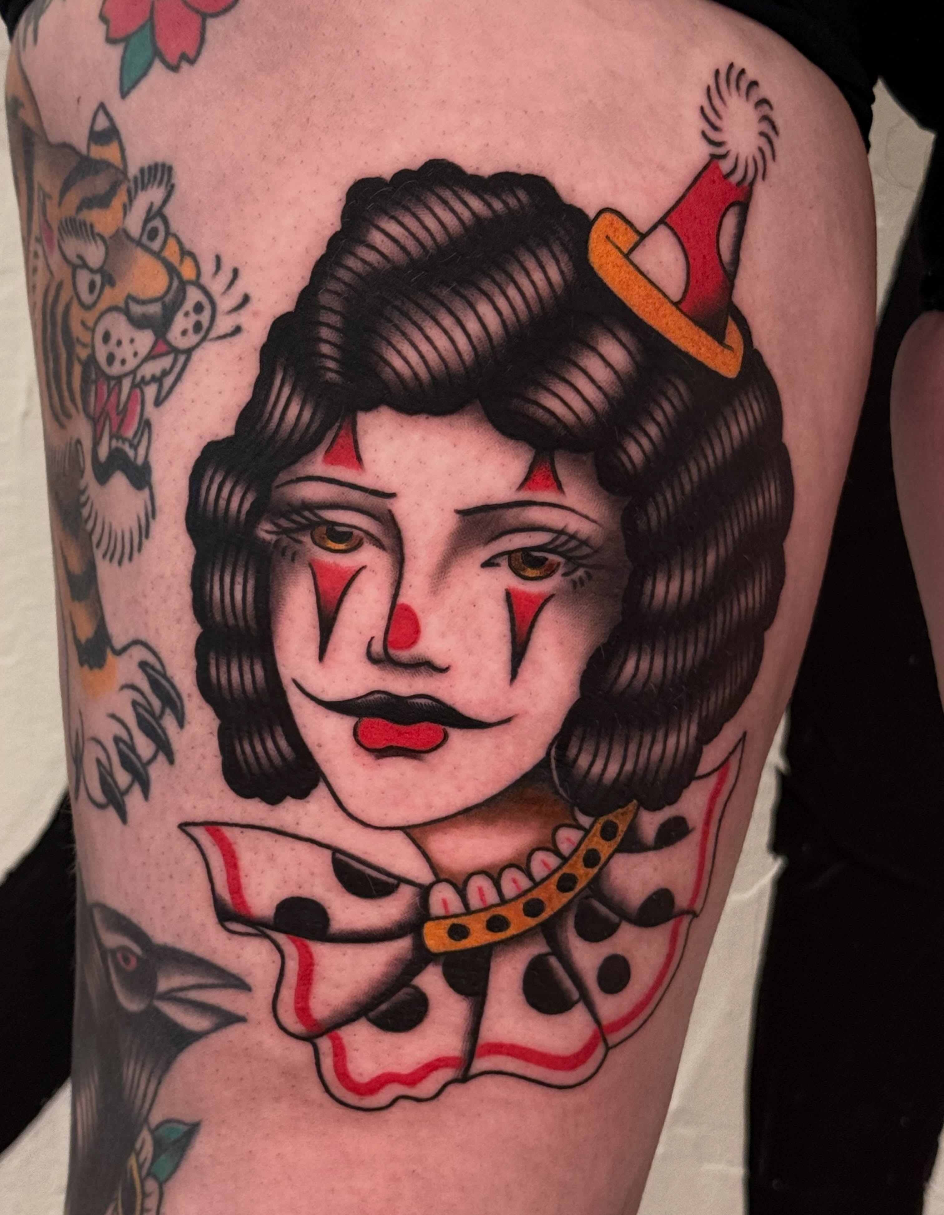 Clown woman American traditional tattoo on the thigh by Cory Allen