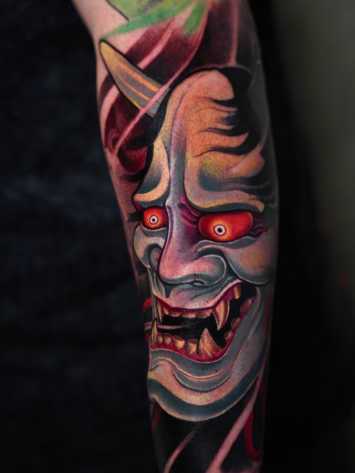 Demon mask dark realism tattoo on the forearm by Grego Hernandez, Miami, Florida