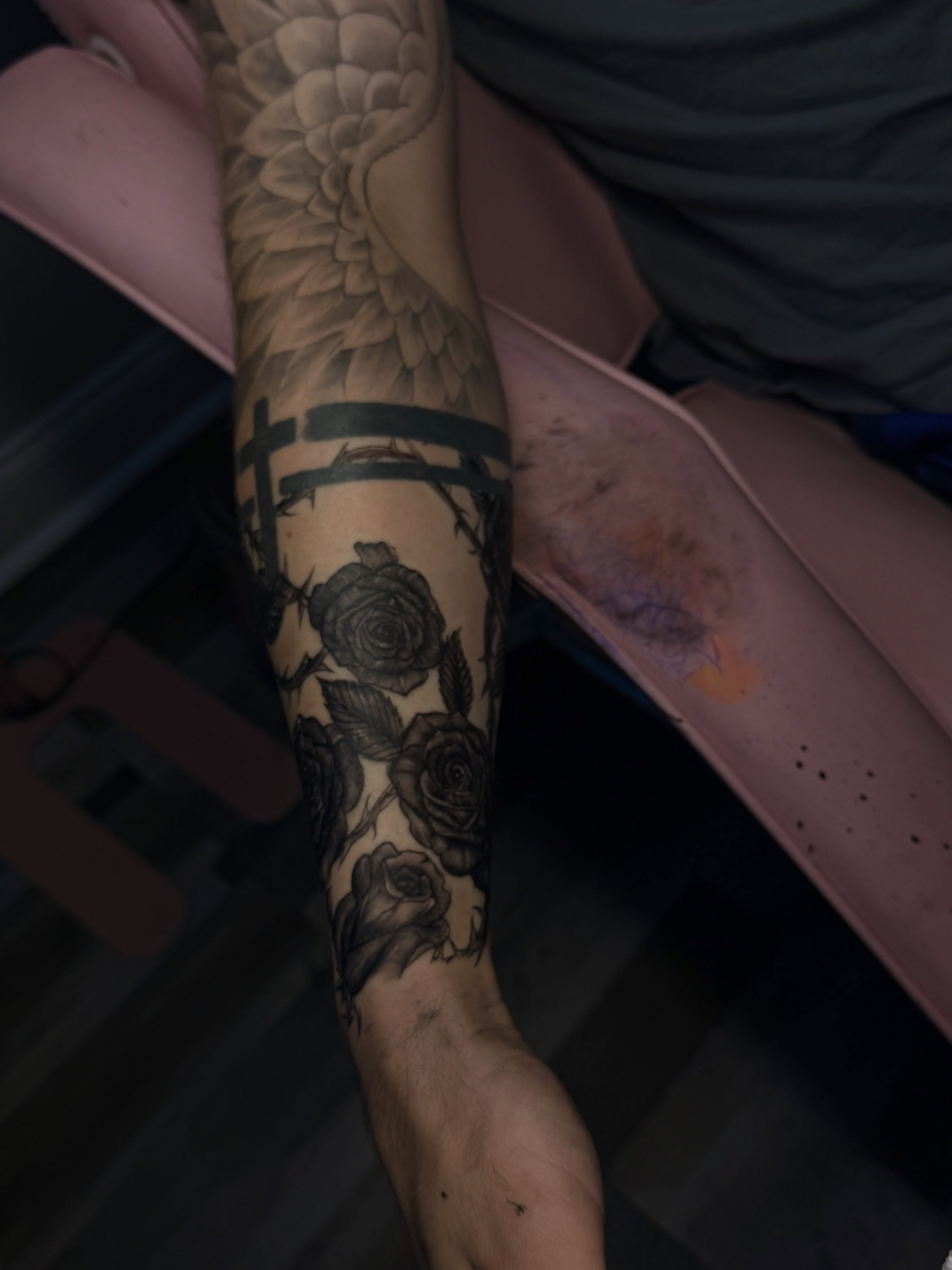Roses and cross black and grey tattoo on the forearm by Tattoos by Santos