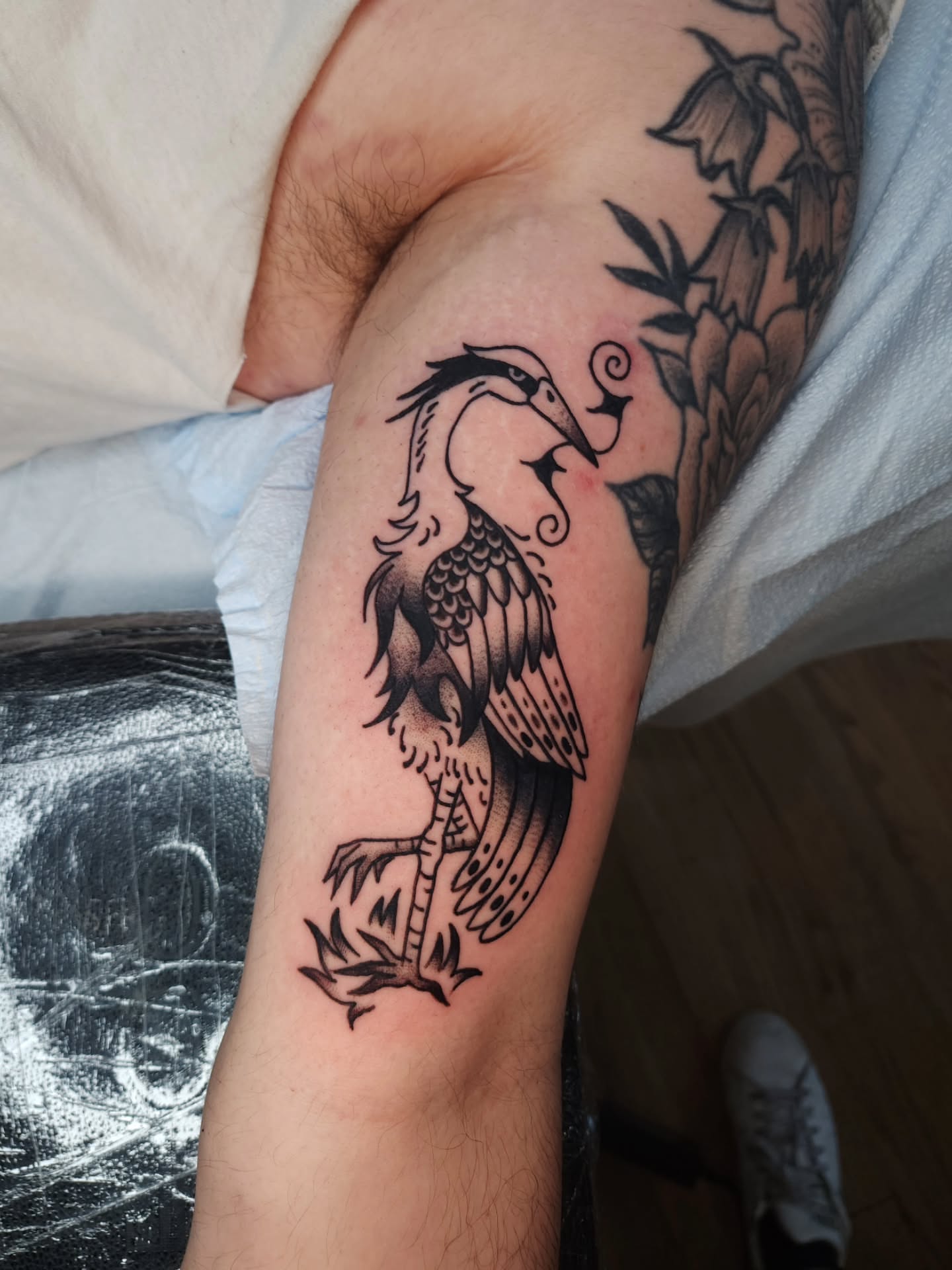 Heron black and grey tattoo on the forearm by Maxine Stewart