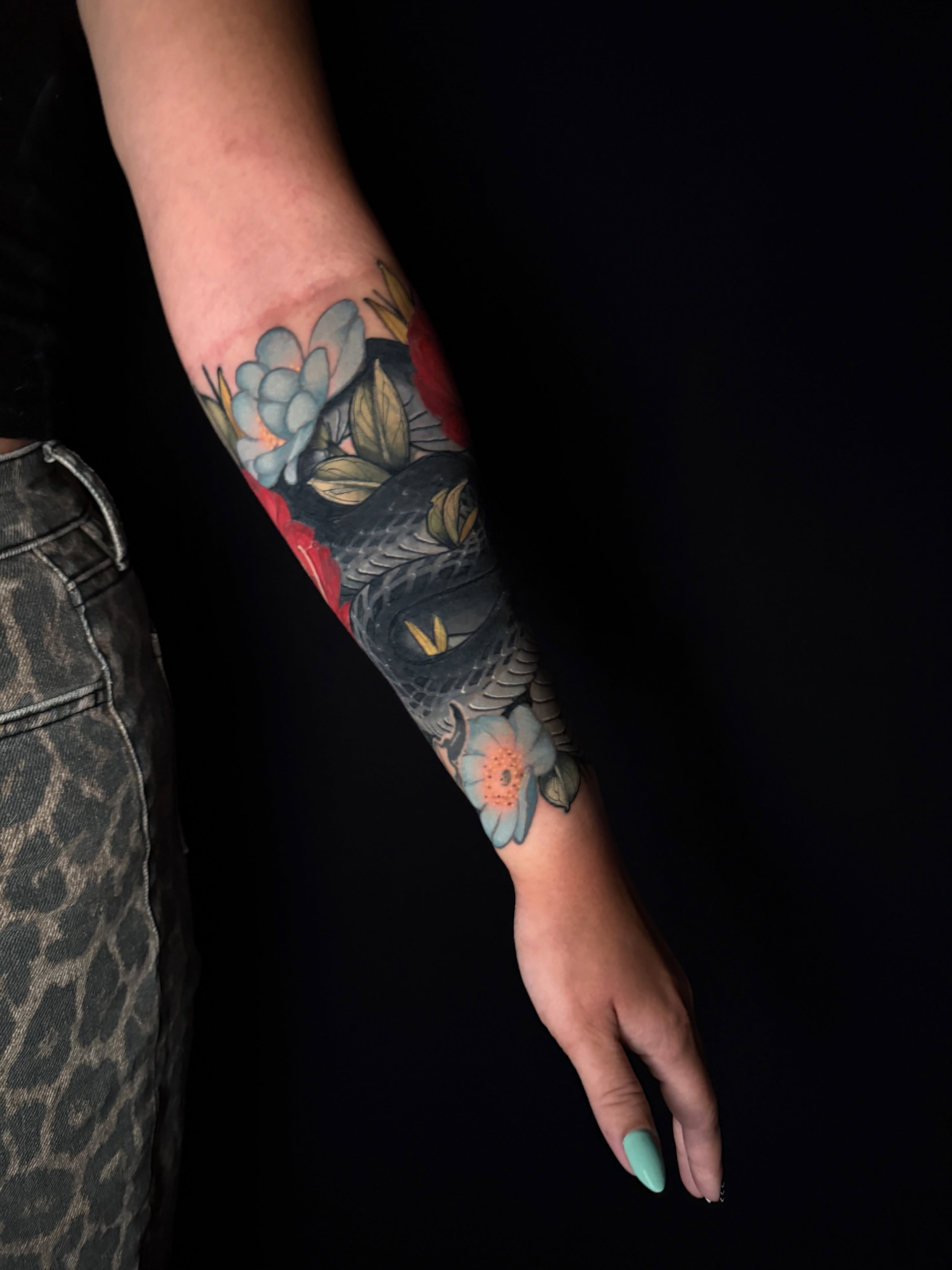 Owl and flowers American traditional tattoo on the forearm by Brad Snow