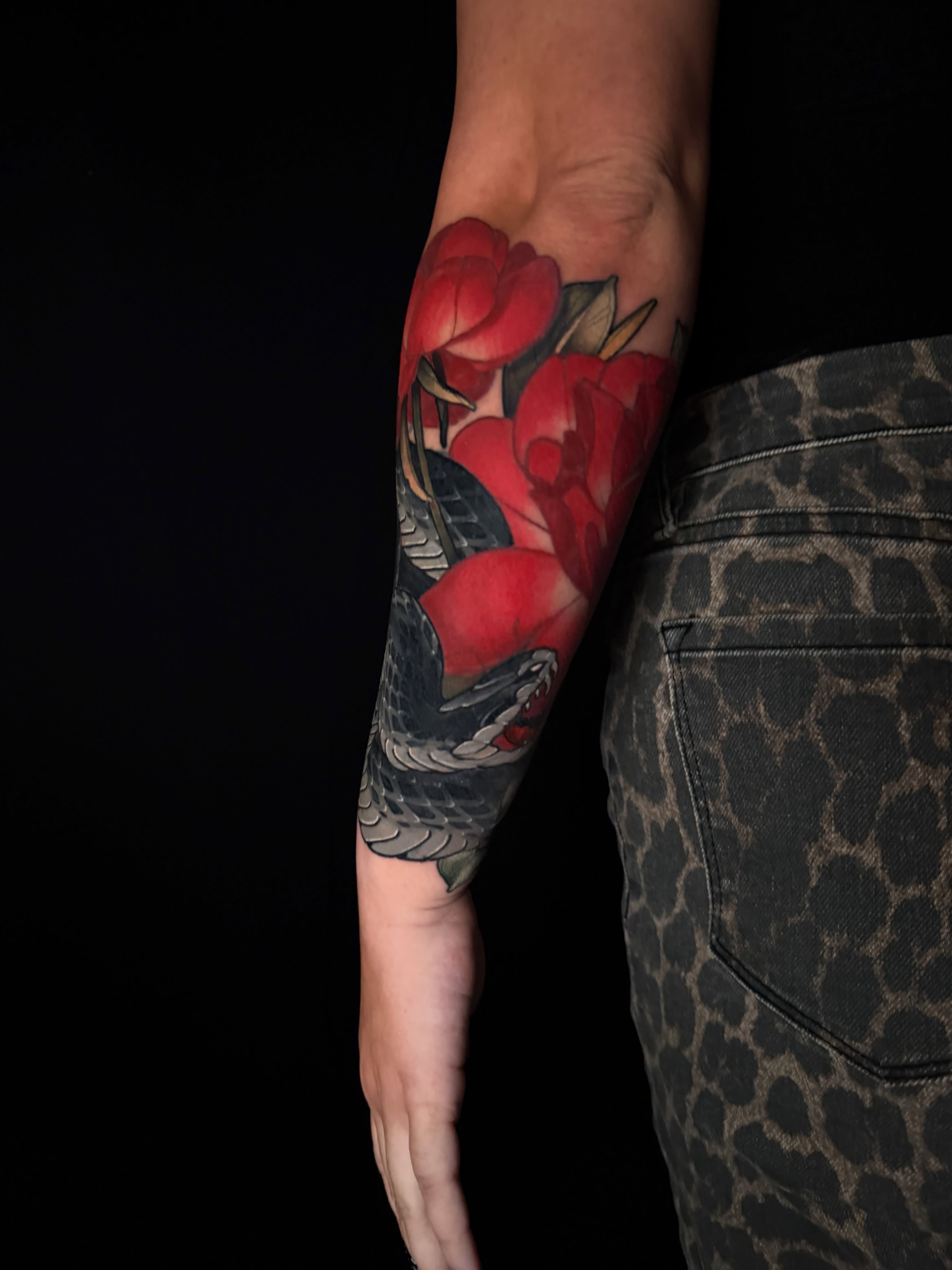 Red roses American traditional tattoo on the forearm by Brad Snow