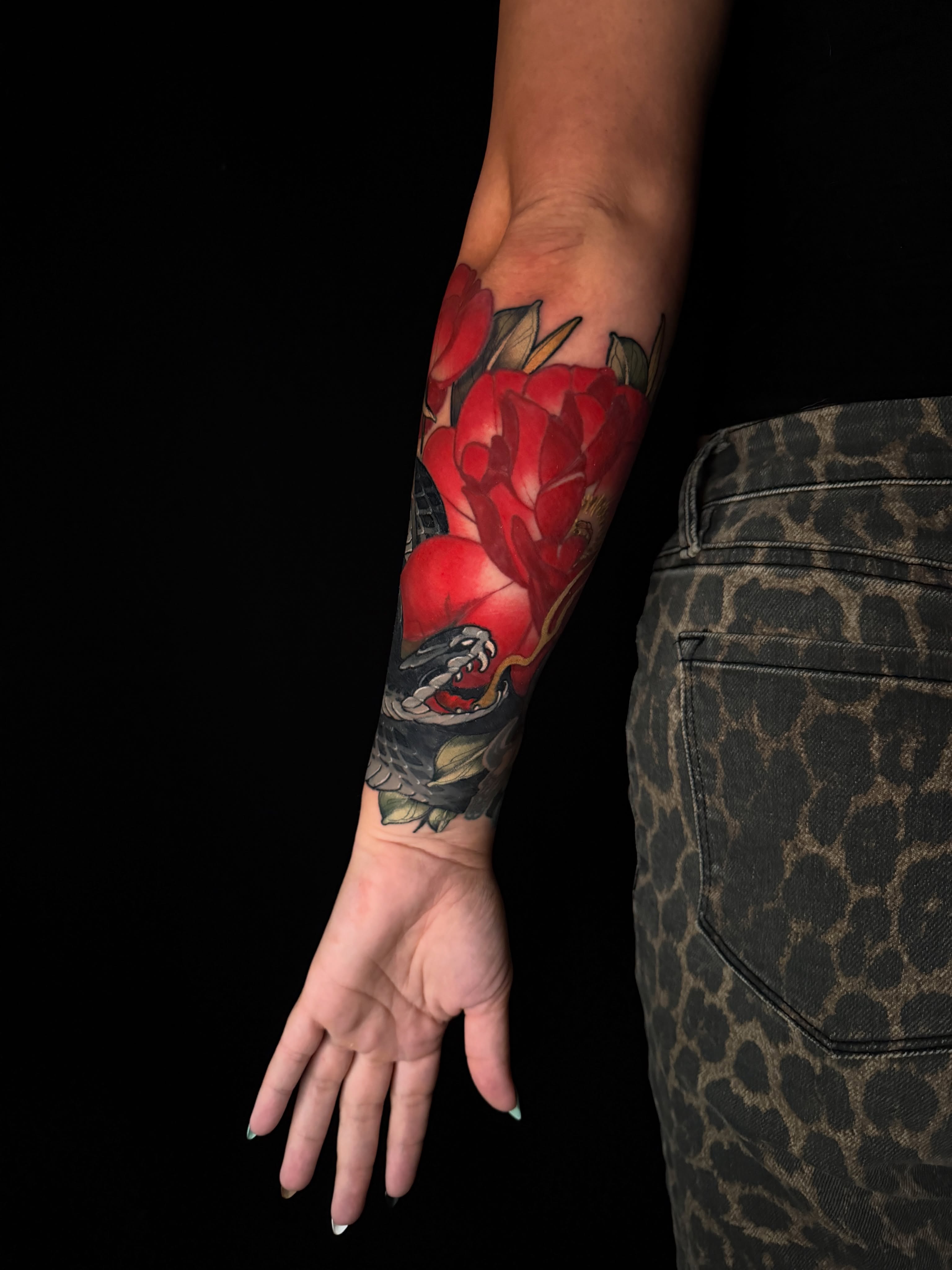 Red roses and snake American traditional tattoo on the forearm by Brad Snow