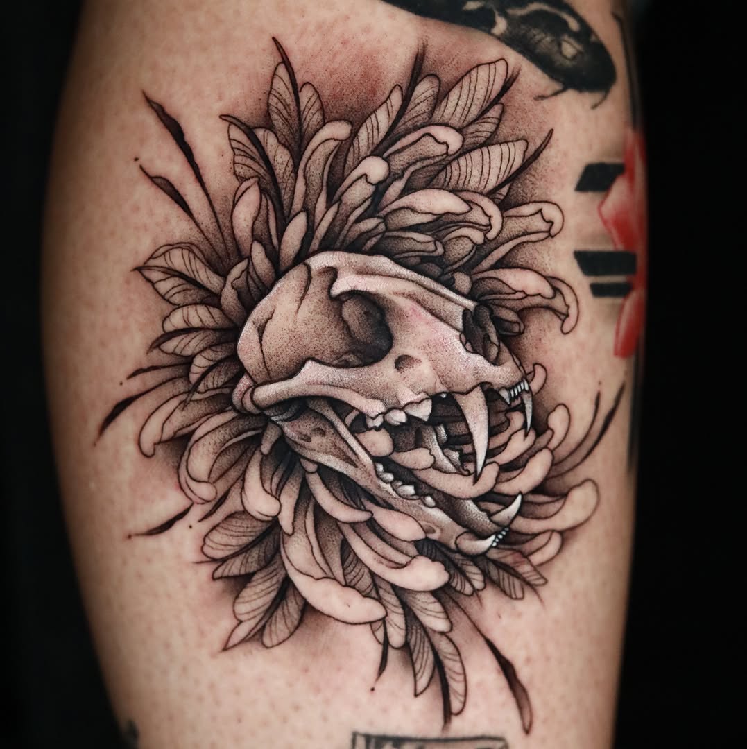 Skull with feathers dotwork tattoo on the forearm by Cuda