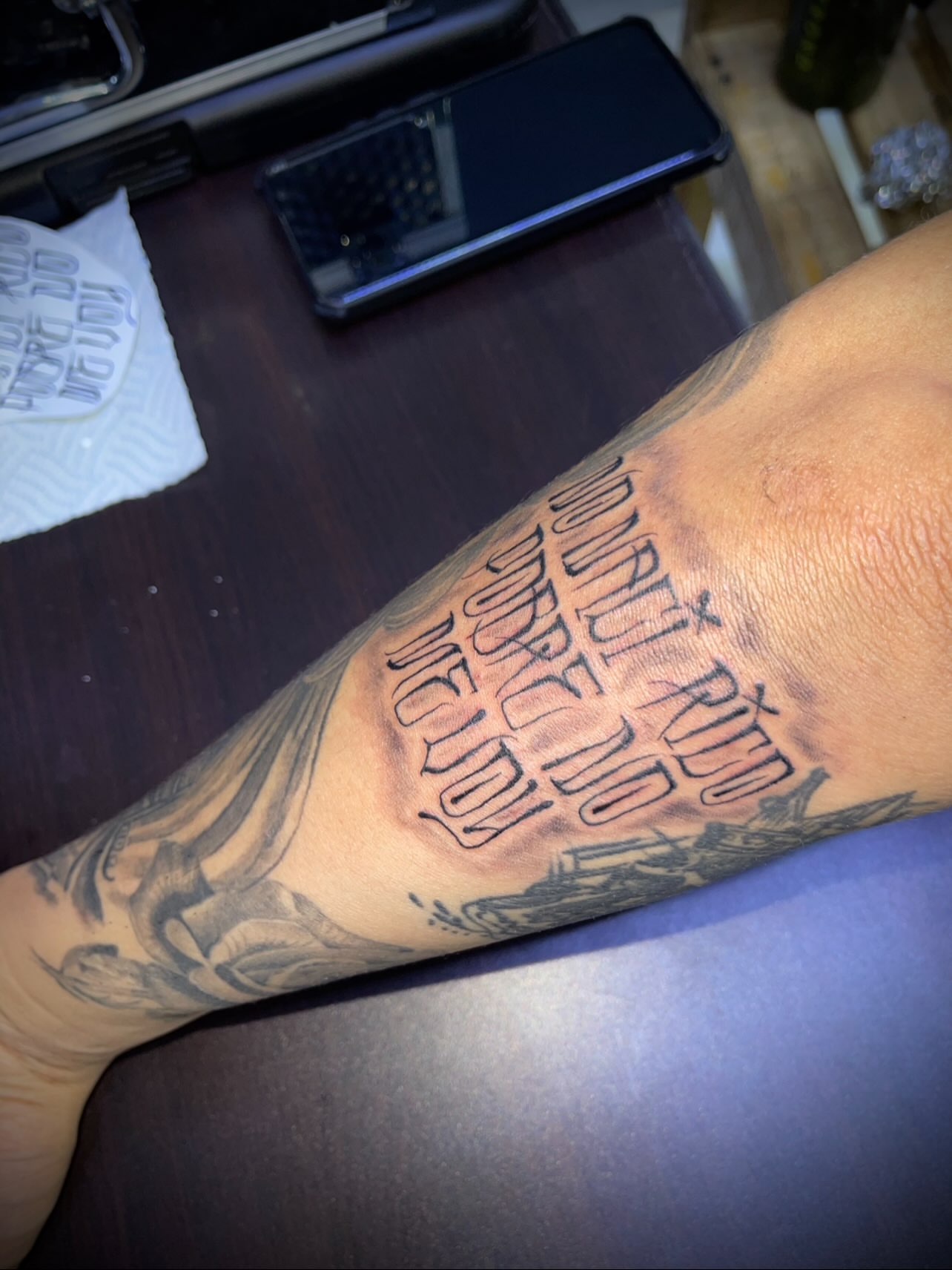 Poor me lettering script tattoo on the forearm by Tu SanchoTattoos