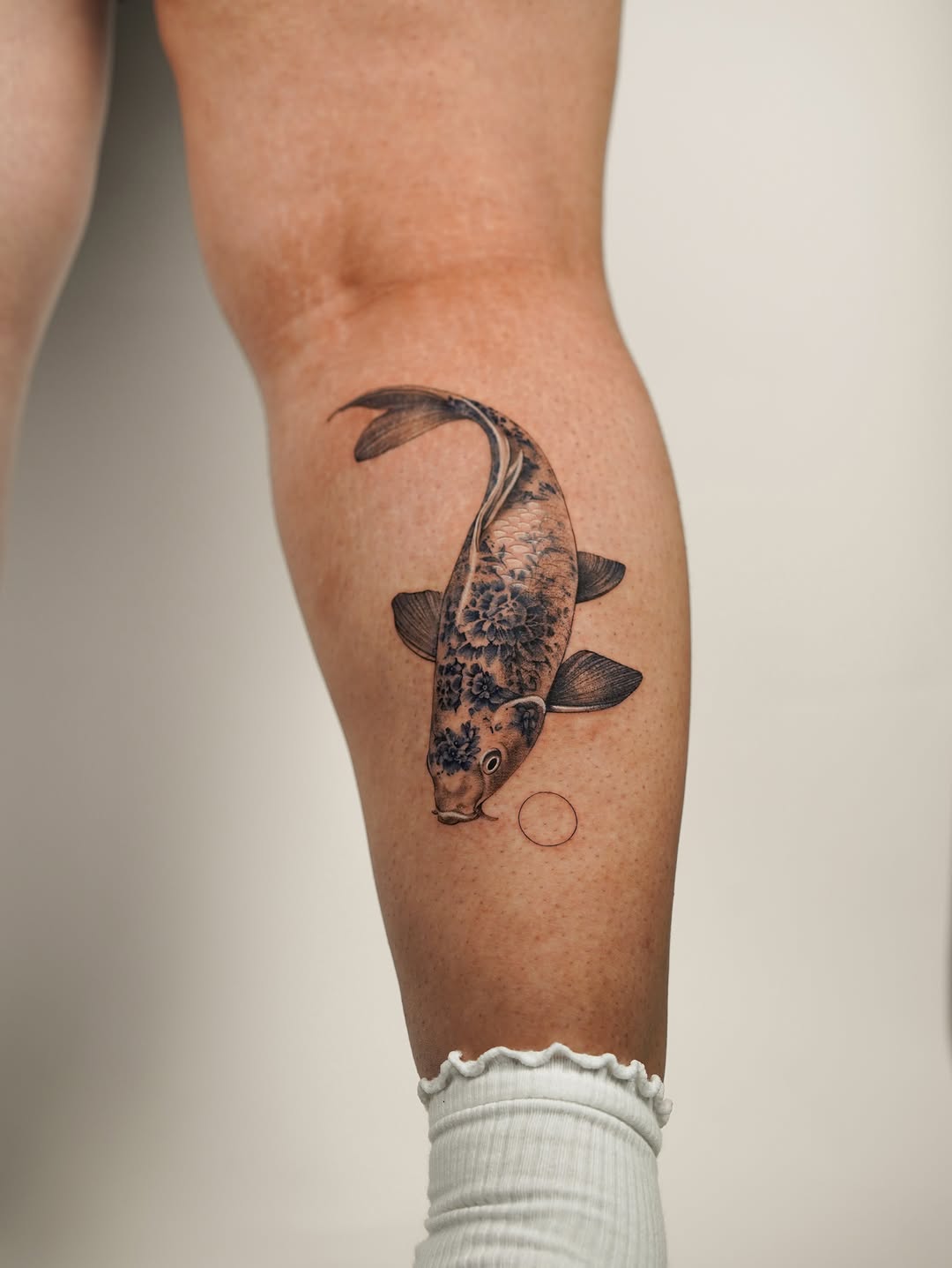 Koi fish fine line tattoo on the forearm by Valentina
