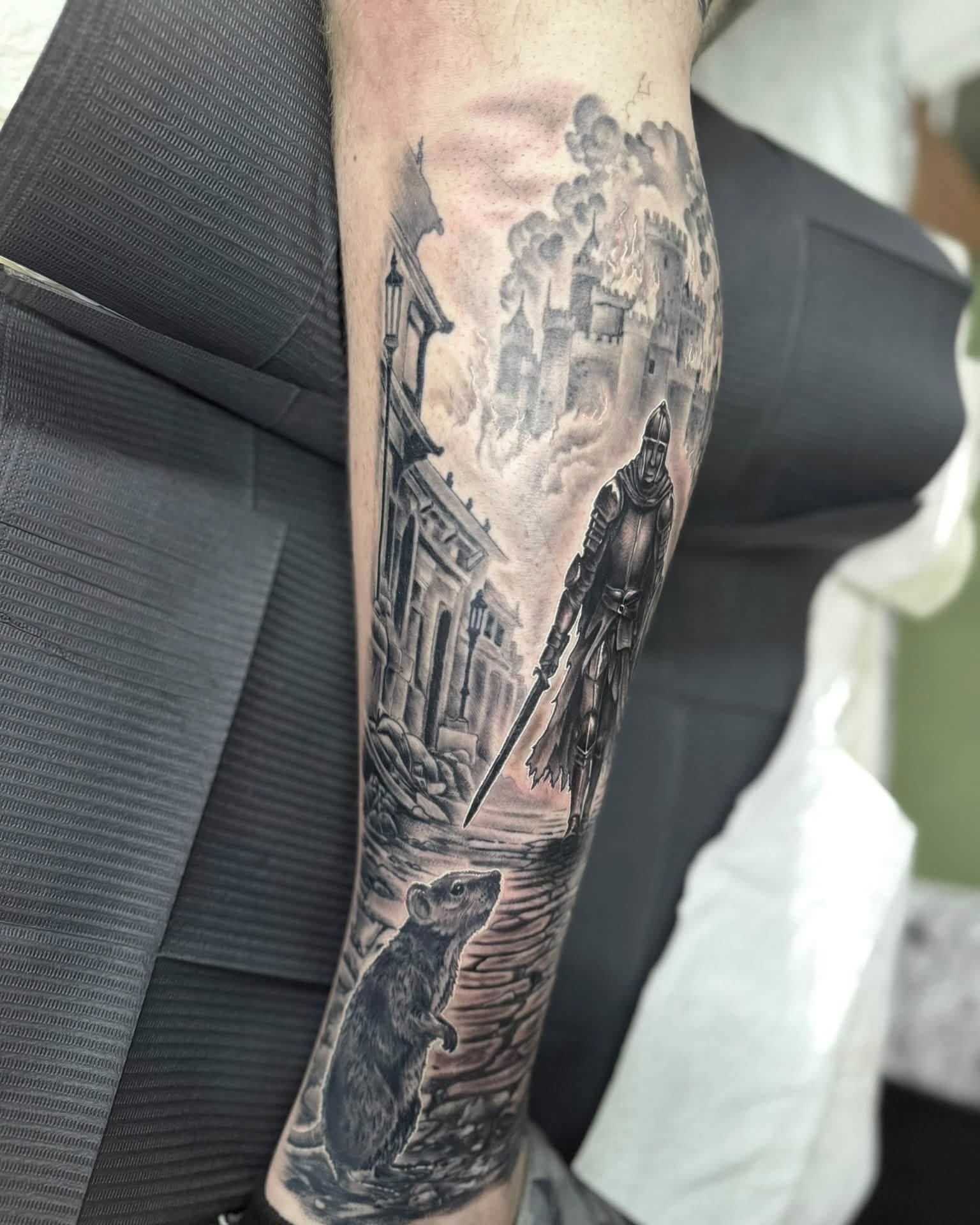 Cityscape with knight and rat realism tattoo on the forearm by Corey Bailey, Stanton, Kentucky