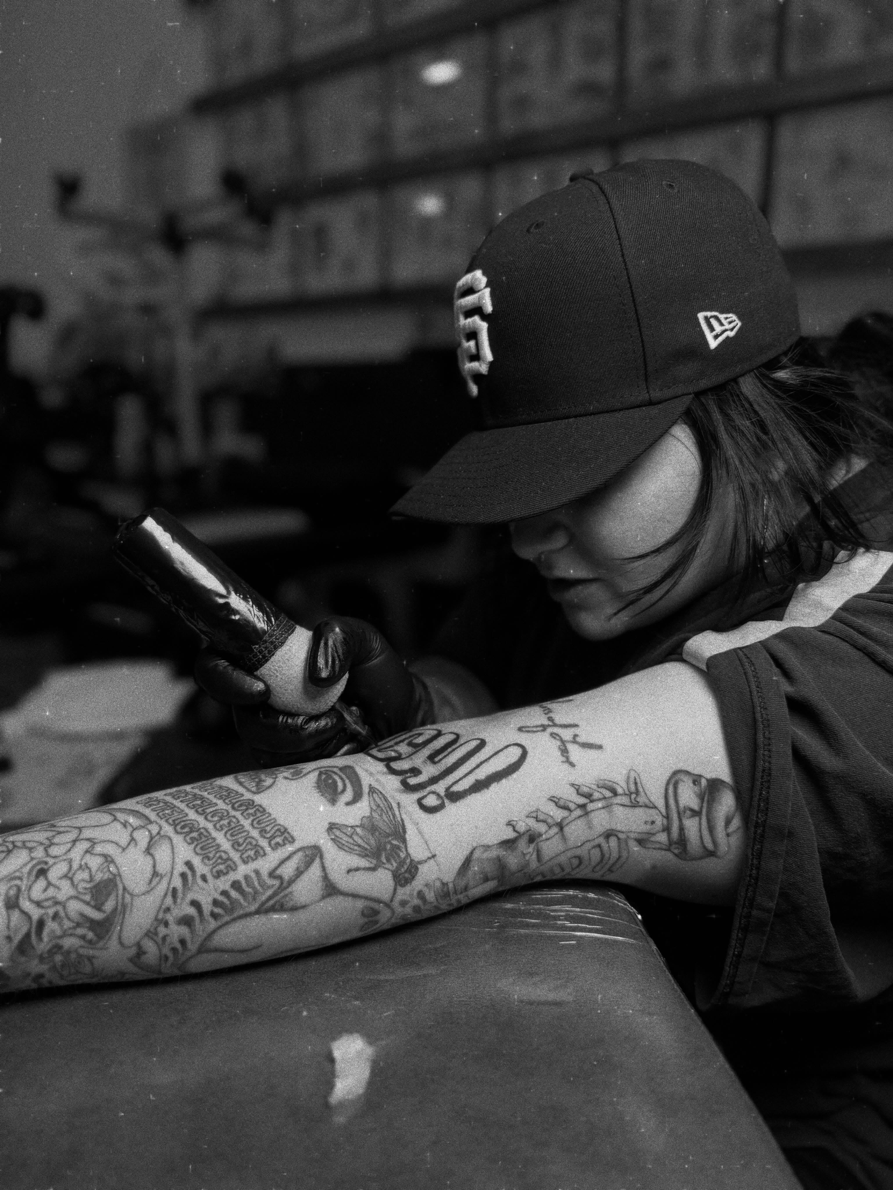 Tattooed arm black and grey tattoo on the upper arm by Sam Padilla
