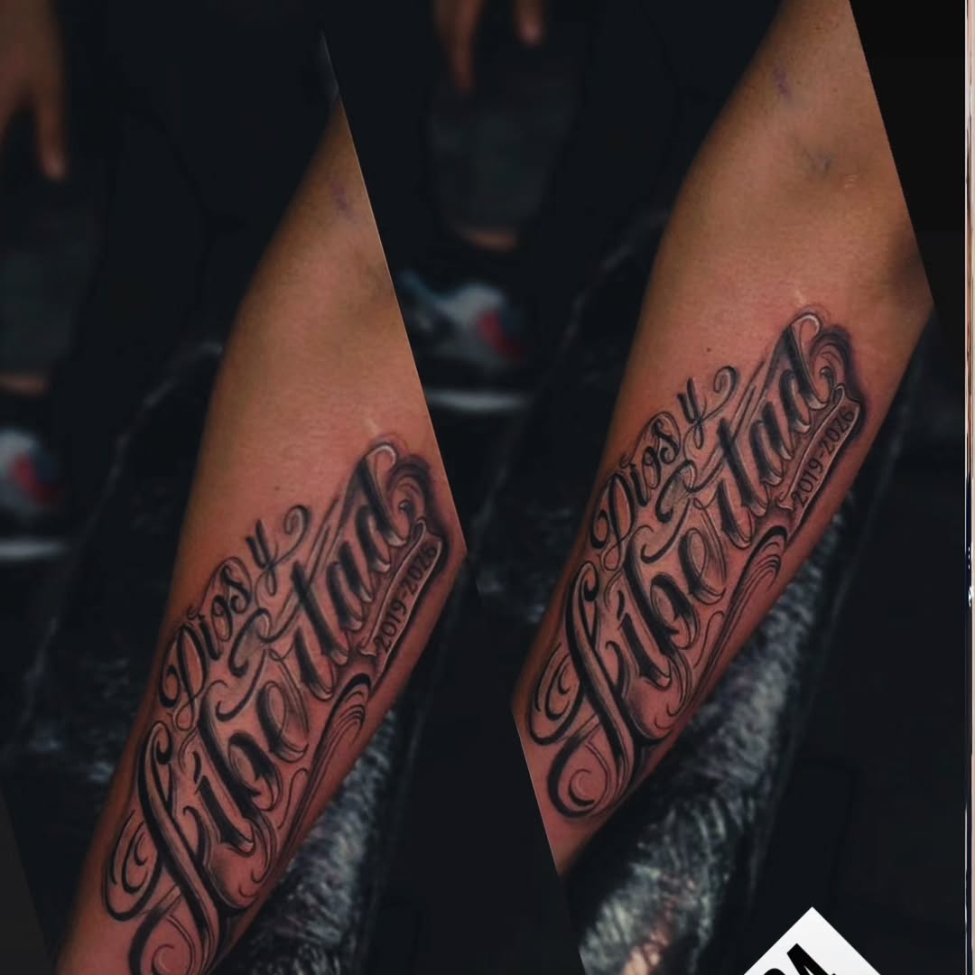 Dios y Libertad lettering Chicano tattoo on the forearm by Kai_Tattoo