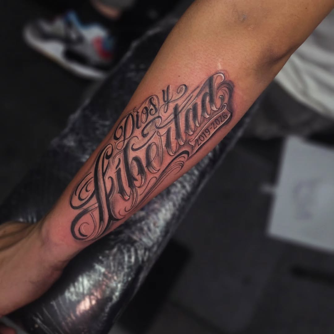 Dios y Libertad text lettering tattoo on the forearm by Kai_Tattoo