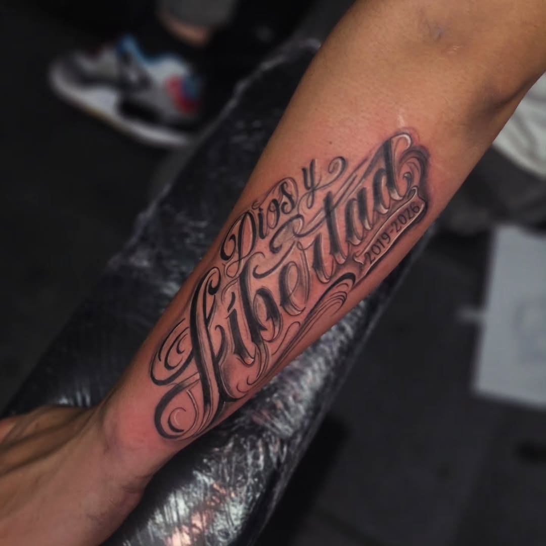 Dios y Libertad 2019-2026 lettering tattoo on the forearm by Kai_Tattoo