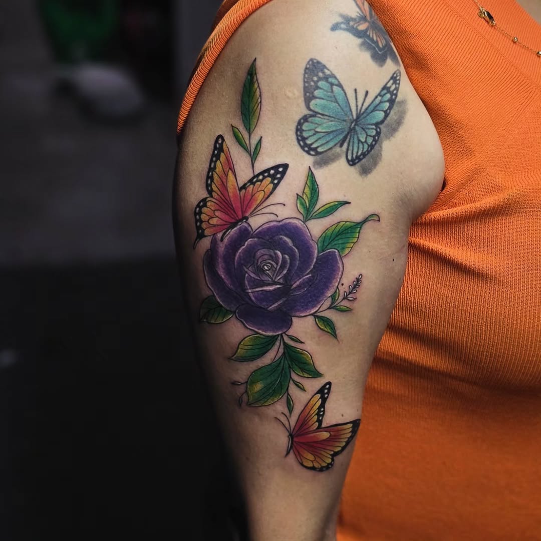 Rose and butterflies neo-traditional tattoo on the upper arm by Kai_Tattoo