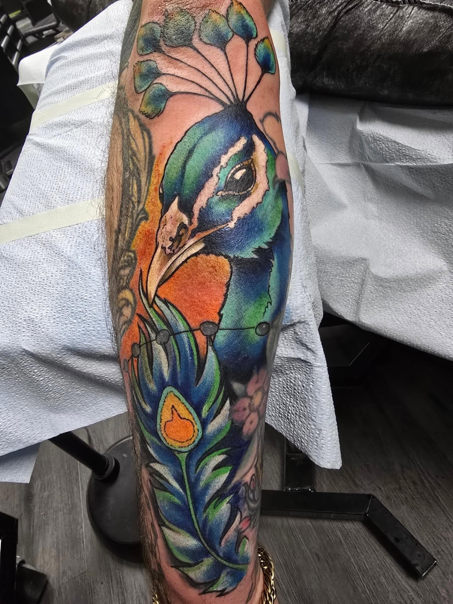 Peacock realism tattoo on the forearm by bonnie