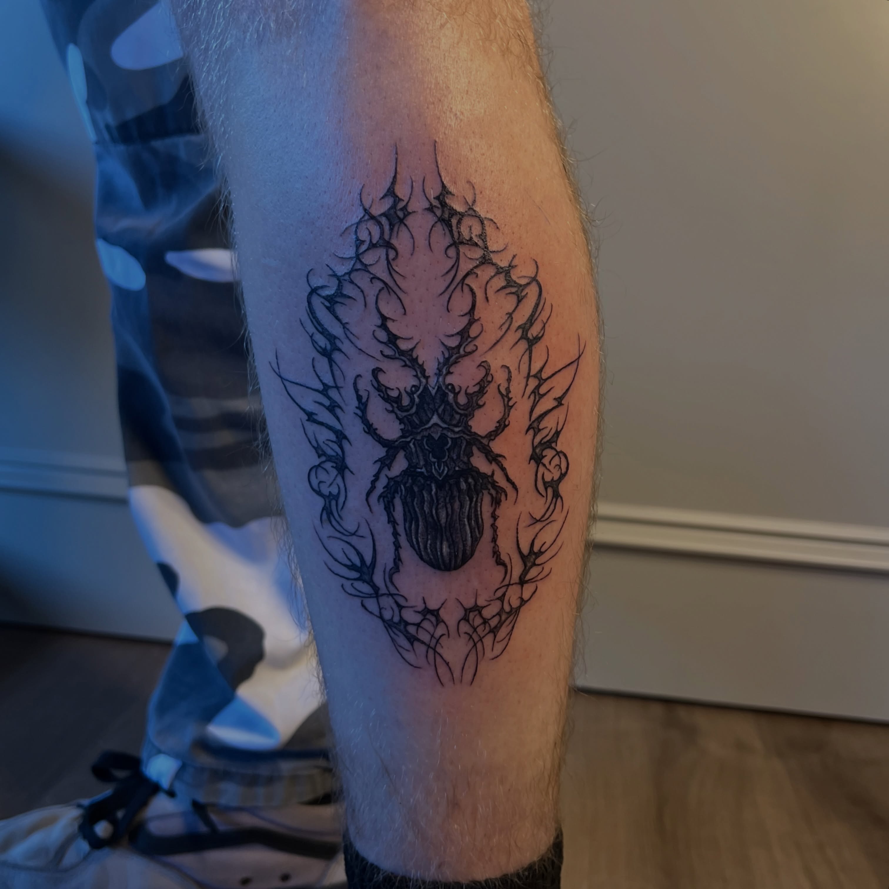 Spider black and grey tattoo on the forearm by Nikki Ward