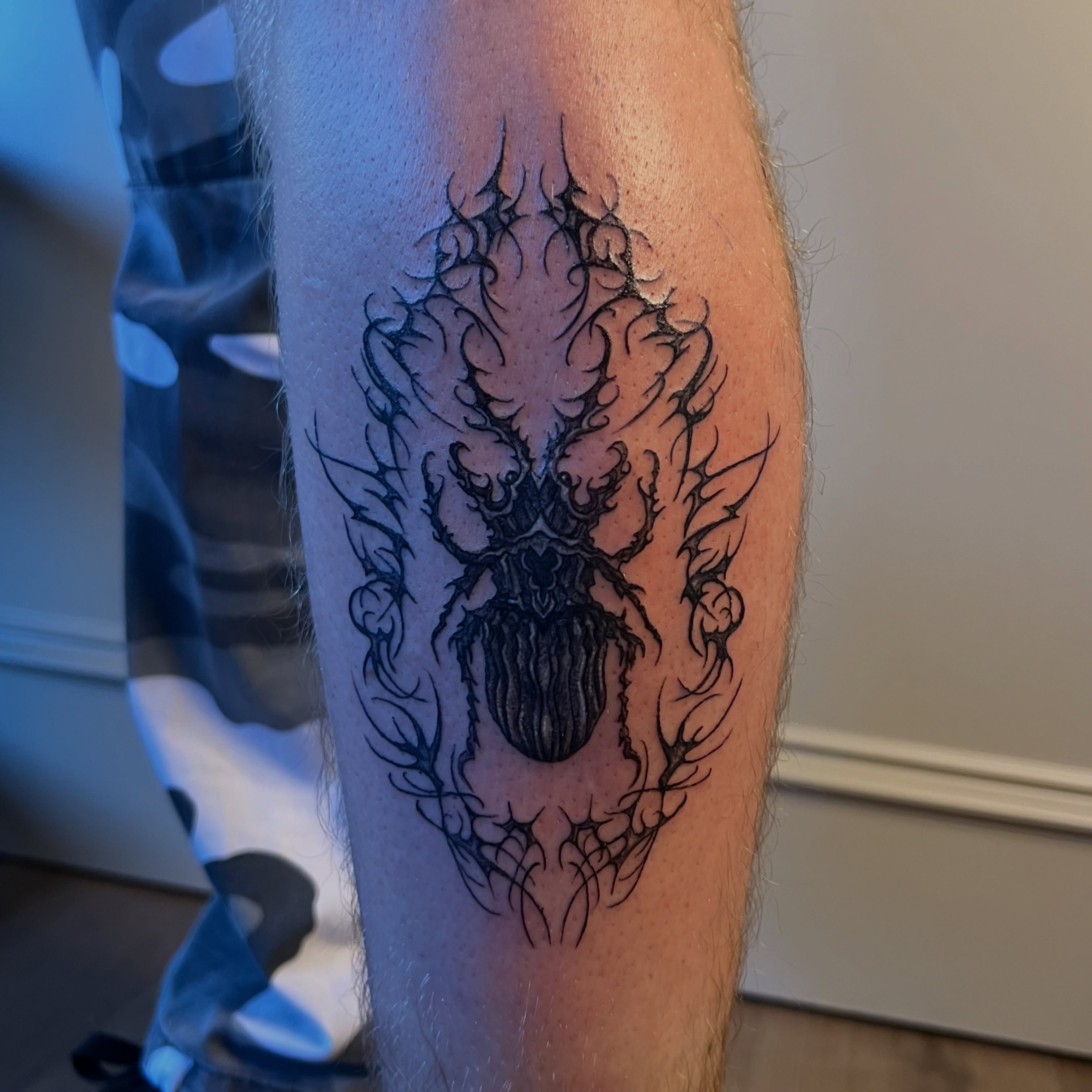 Spider geometric tattoo on the forearm by Nikki Ward