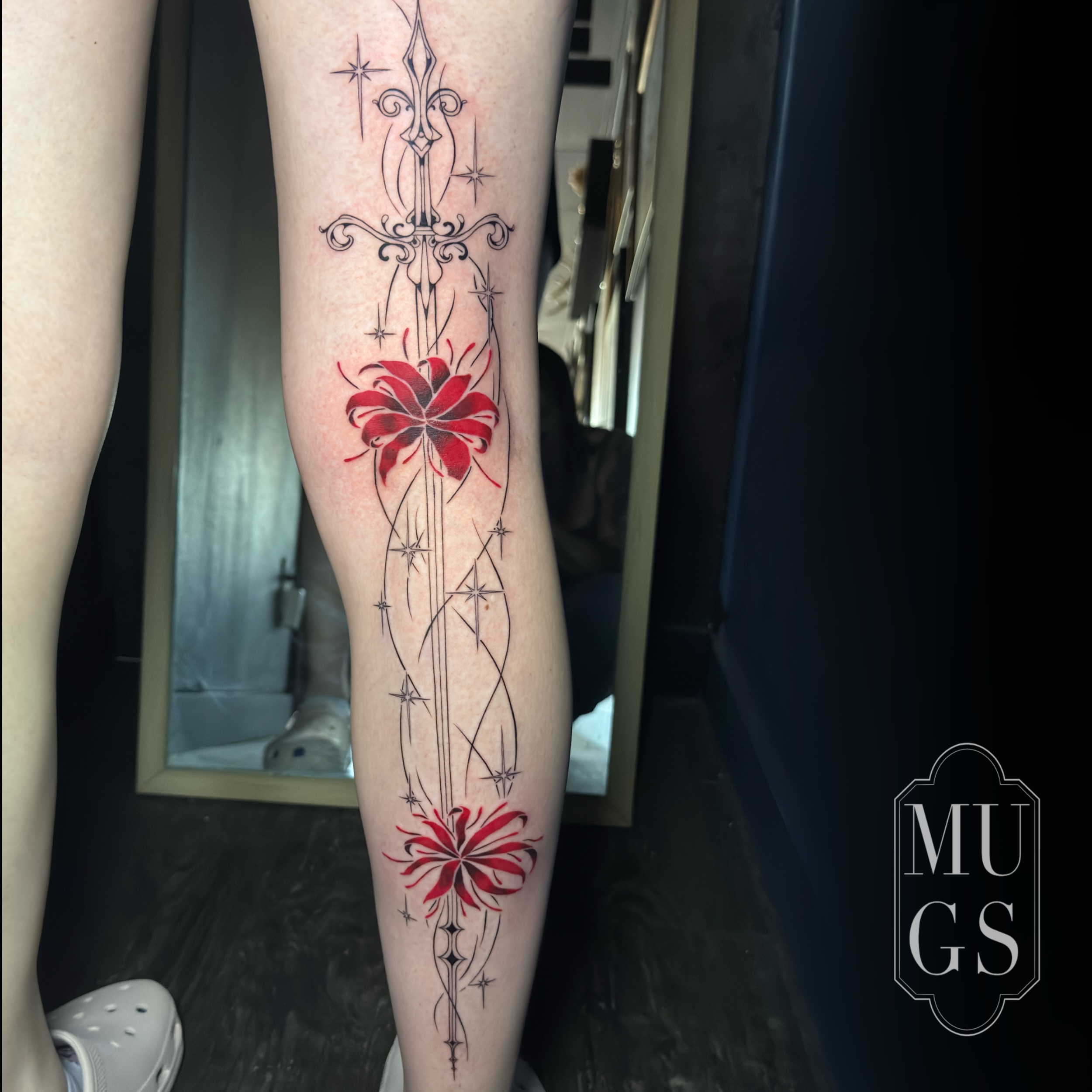 Red lily and sword neo-traditional tattoo on the calf by Emily Andreozzi