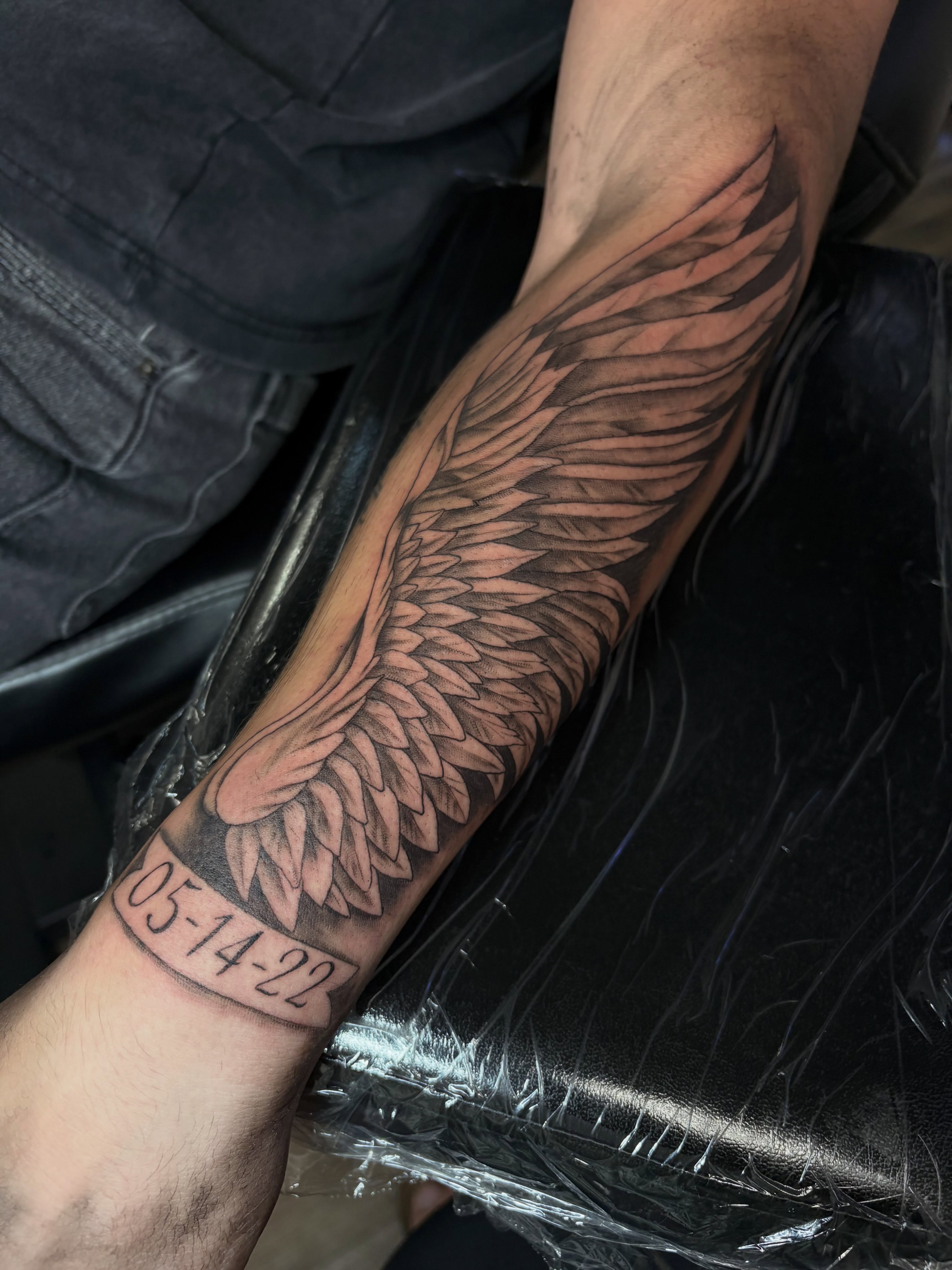 Wing black and grey tattoo on the forearm by Cincinnati Tattoo Artist