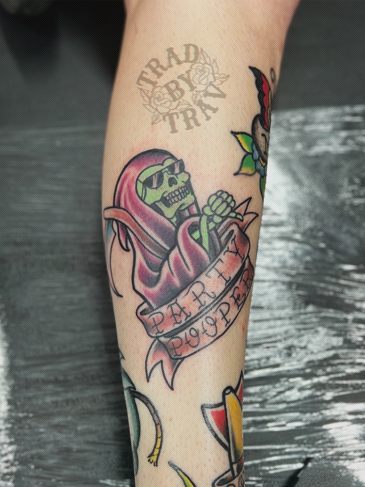 Skull with banner American traditional tattoo on the forearm by Travis B