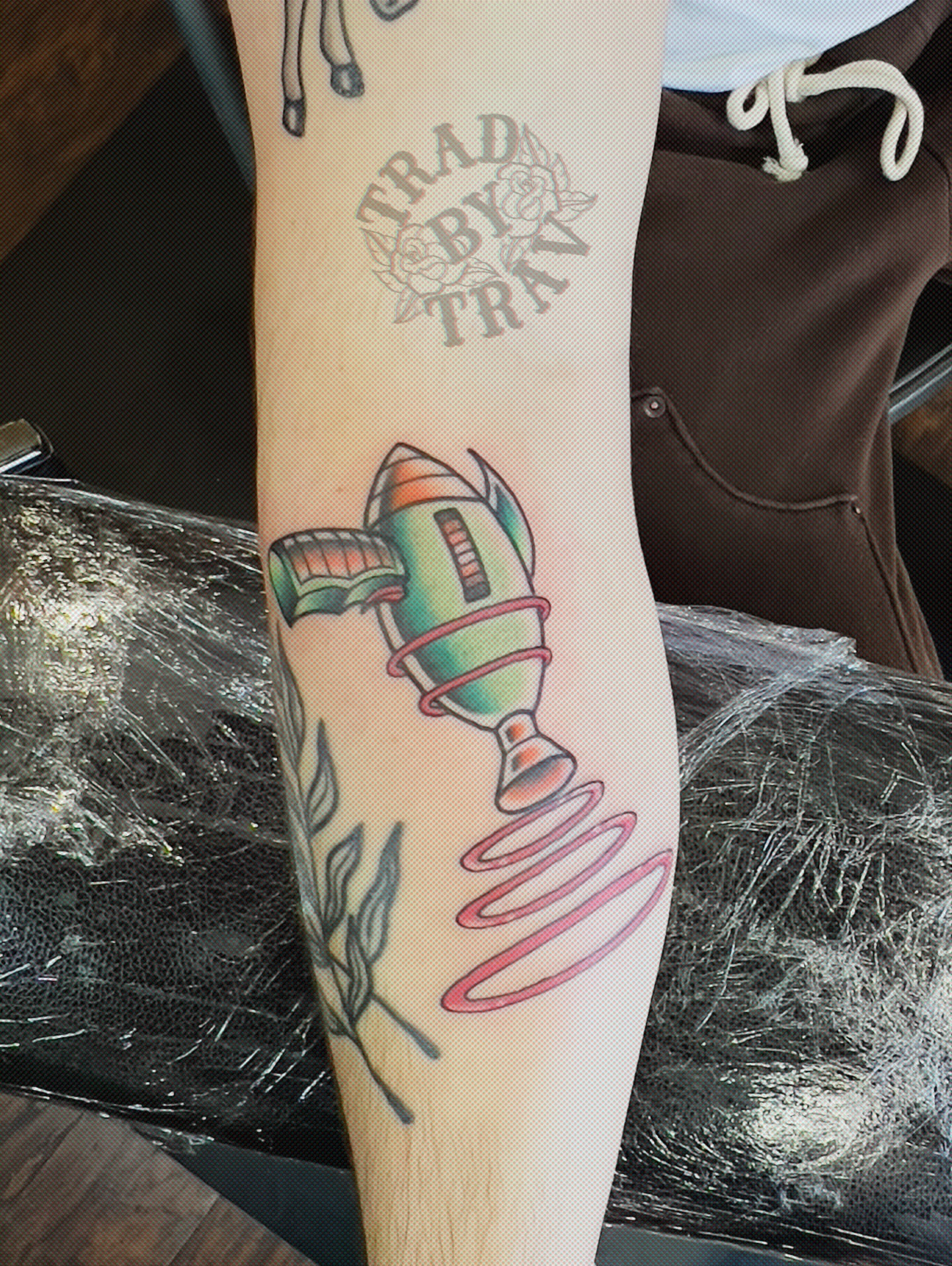 Rocket ship American traditional tattoo on the forearm by Travis B
