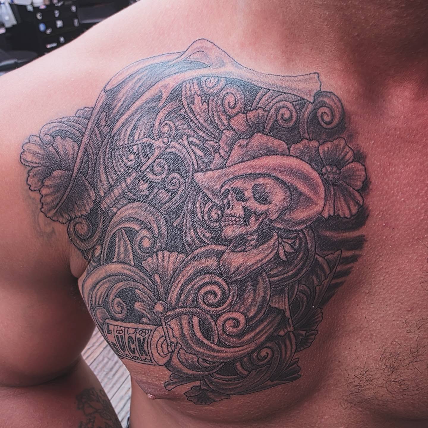 Skull with sombrero Chicano tattoo on the shoulder by Jeff Frederick